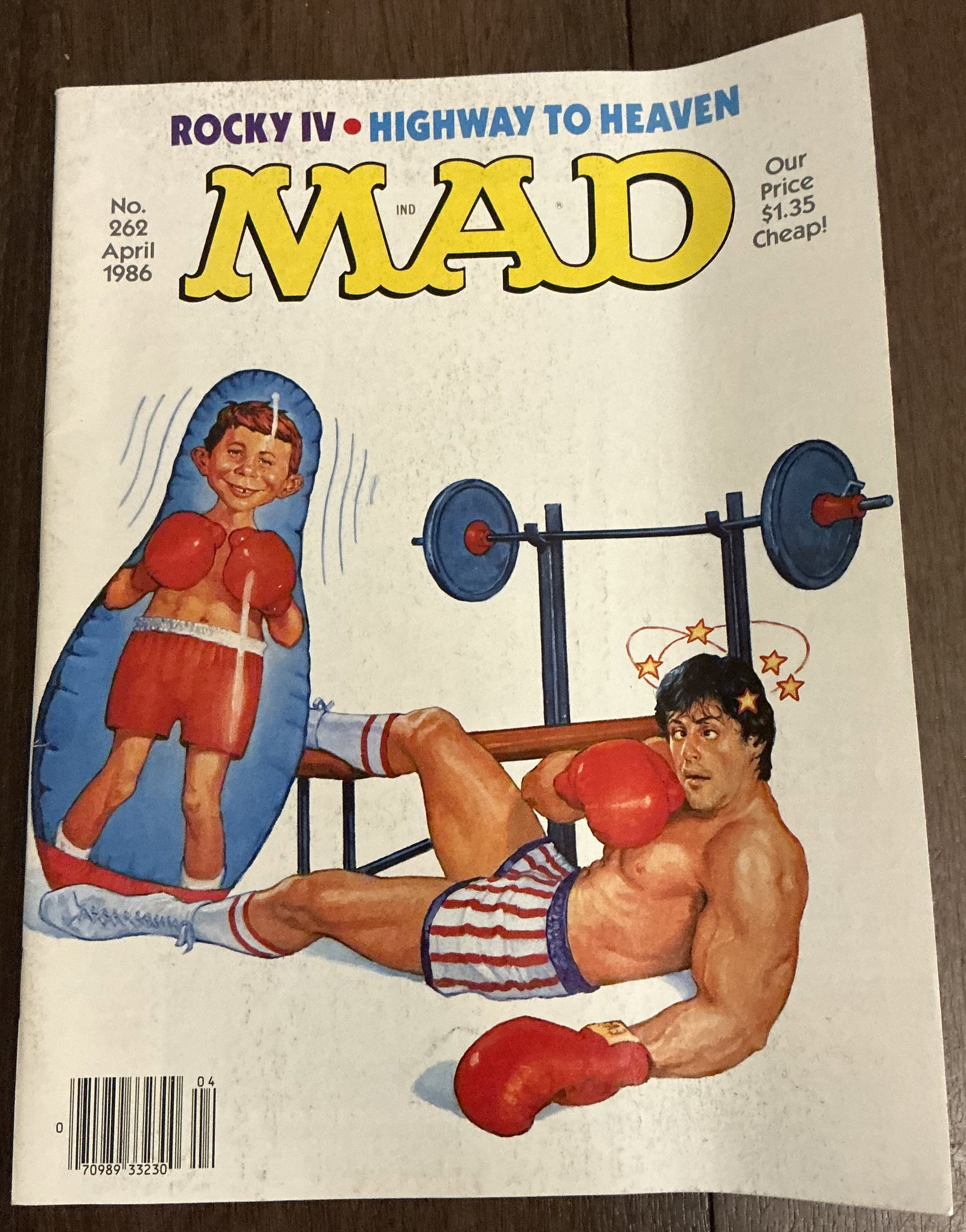 MAD Magazine No. 262 April 1986: MAD Magazine No. 262 April 1986. This issue features a cover parody of the blockbuster film Rocky IV, with Alfred E. Neuman humorously replacing Rocky Balboa in a boxing scene inspired by Sylvester