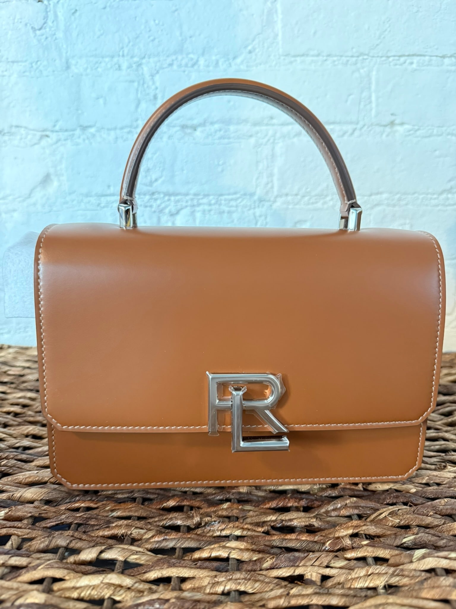 Ralph Lauren Collection Stacked RL Top Handle Bag: Ralph Lauren Collection Stacked RL Top Handle Bag Tan leather construction. Includes detachable/adjustable crossbody strap. External back pocket and internal pocket. Locking mechanism in RL logo.