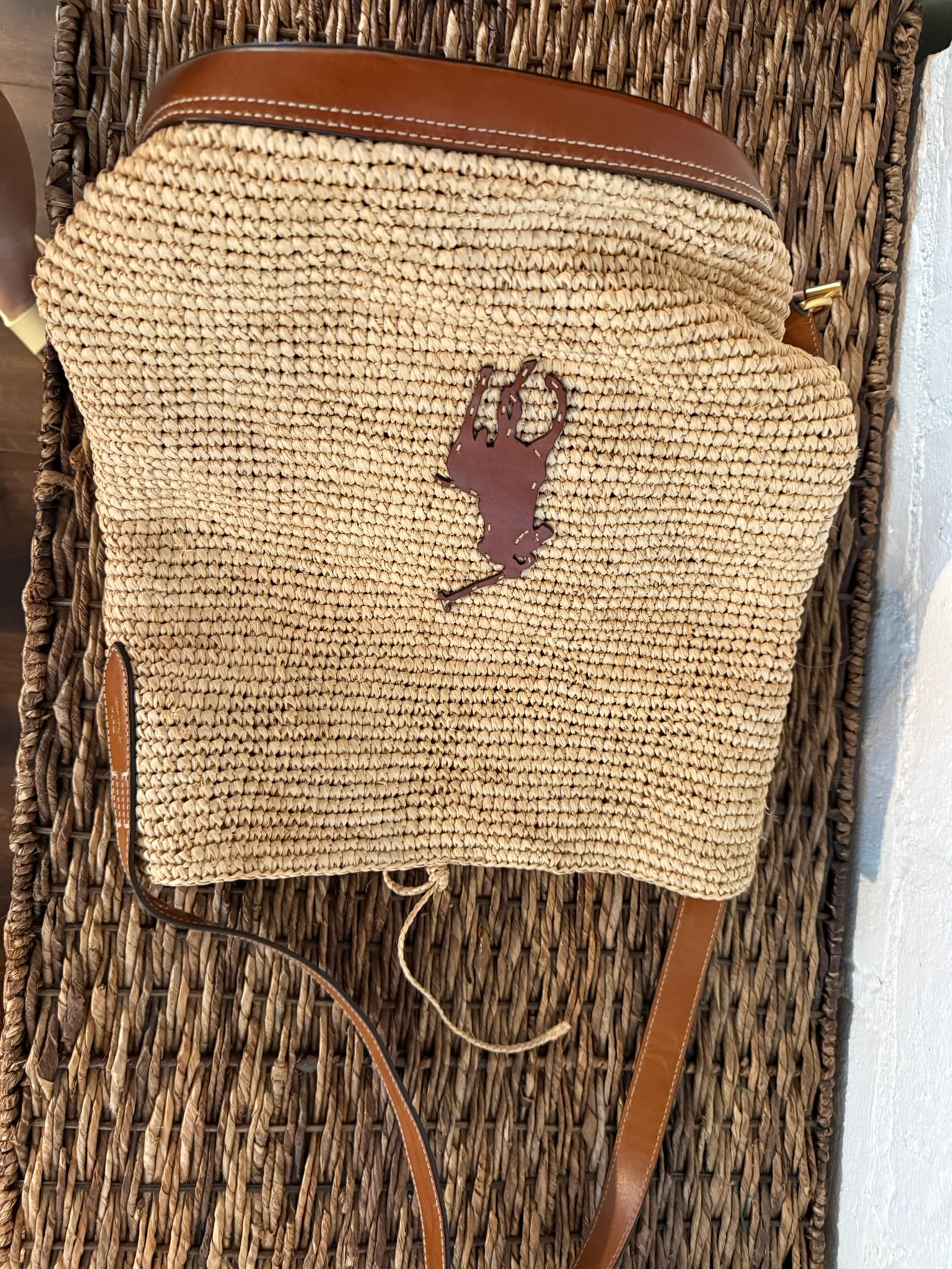 Polo Ralph Lauren Polo Player Raffia Bucket Bag- Large: Natural tan Polo Ralph Lauren Polo Player Raffia Bucket Bag- Large Lightweight open weave raffia bag with leather polo logo and straps. Internal drawstring closure canvas bag. Lightly used with
