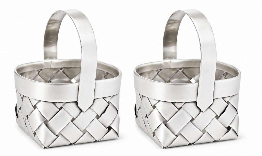 Pair of Cartier Sterling Silver Woven Baskets: Rare pair of Cartier sterling silver woven baskets crafted in an exquisite, realistic manner. They measure 3'' by 2 1/2'' by 2'' and bear hallmarks as shown.Founded by Louis-François Cartier in Paris