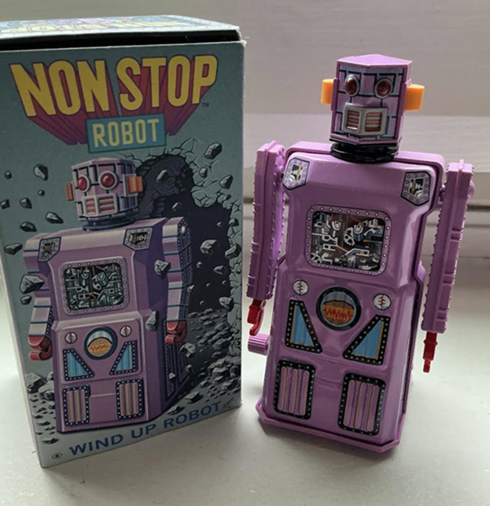 Masudaya "Non-Stop Lavender Windup Robot" from the "Gang of Five" In Box Made in Japan: Masudaya "Non-Stop Lavender Windup Robot" from the "Gang of Five" Made in Japan Measures approx 4.5 inches tall