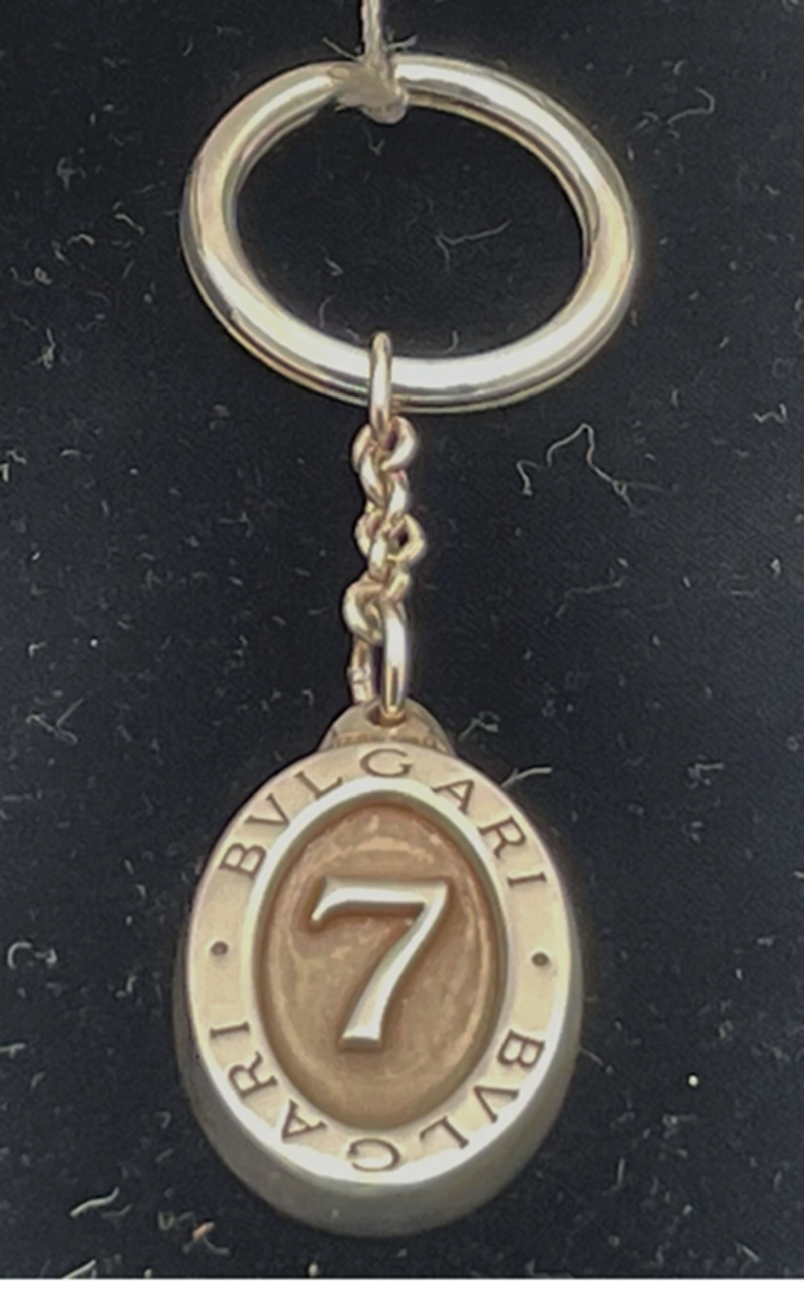 Bulgari Sterling Silver Lucky 7 Keychain With Box: Bulgari sterling silver keychain in heavy gage silver. It measures 3 3/4'' in total length by 7/8'' in width at the largest point by 1/8'' in depth, bears English hallmarks as shown, and is sold new i