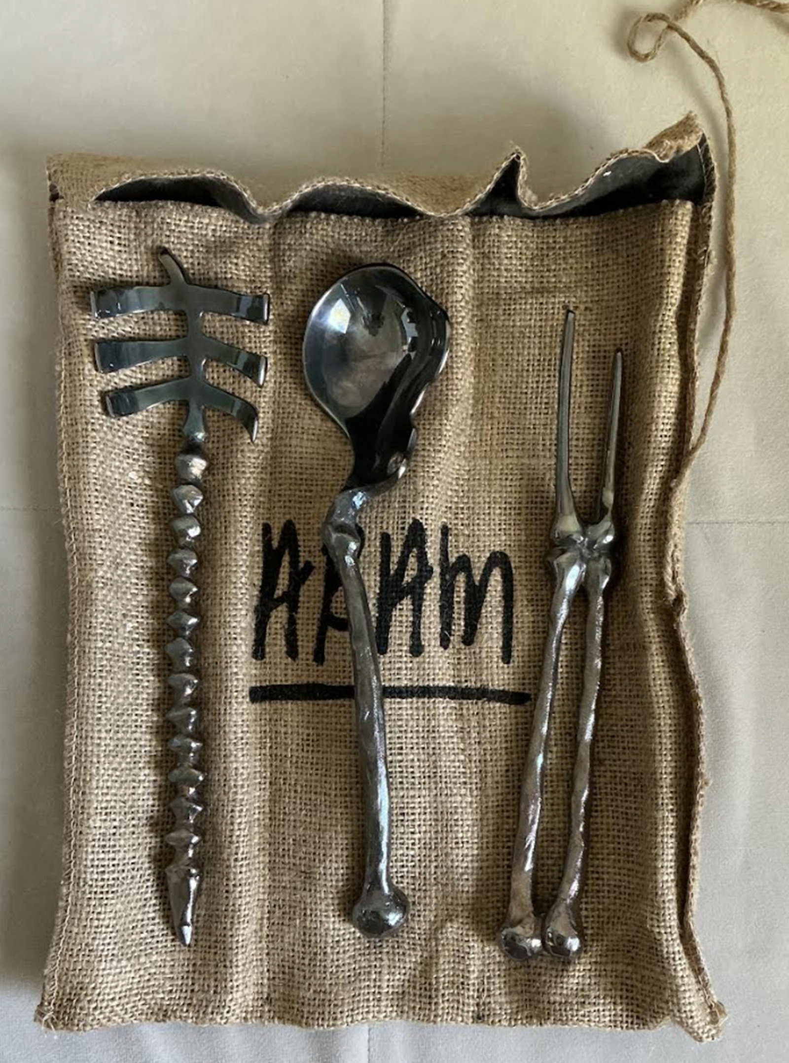 MICHAEL ARAM BONEWARE SKELETON BONE SERVING SET WITH POUCH: MICHAEL ARAM BONEWARE SKELETON BONE Serving Set Include FORK/ SPOON / TONG And Pouch. Femur Hip Bone Serving Spoon approx 10.5"Meat Fork Leg Bones approx 9.75"Serving Tongs Ribs/Spine approx 10.5"