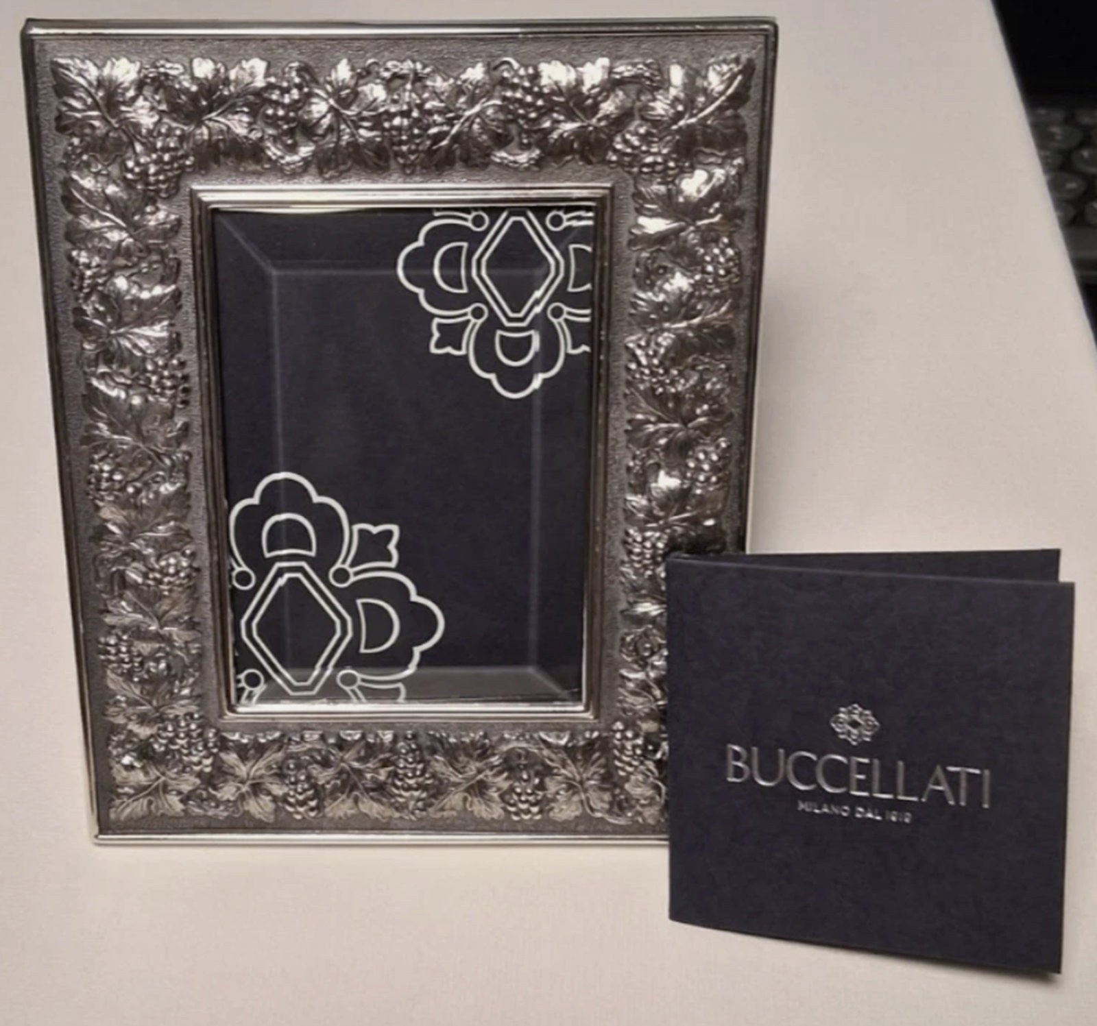 Buccellati Sterling Silver Grape Design Picture Frame With Box: Buccellati Sterling Silver Grape Design Picture Frame With Box. Measures Dimensions: Exterior: 5.25” L x 4.25” W; Interior/Window: 3.25” L x 2.25” W New Condition