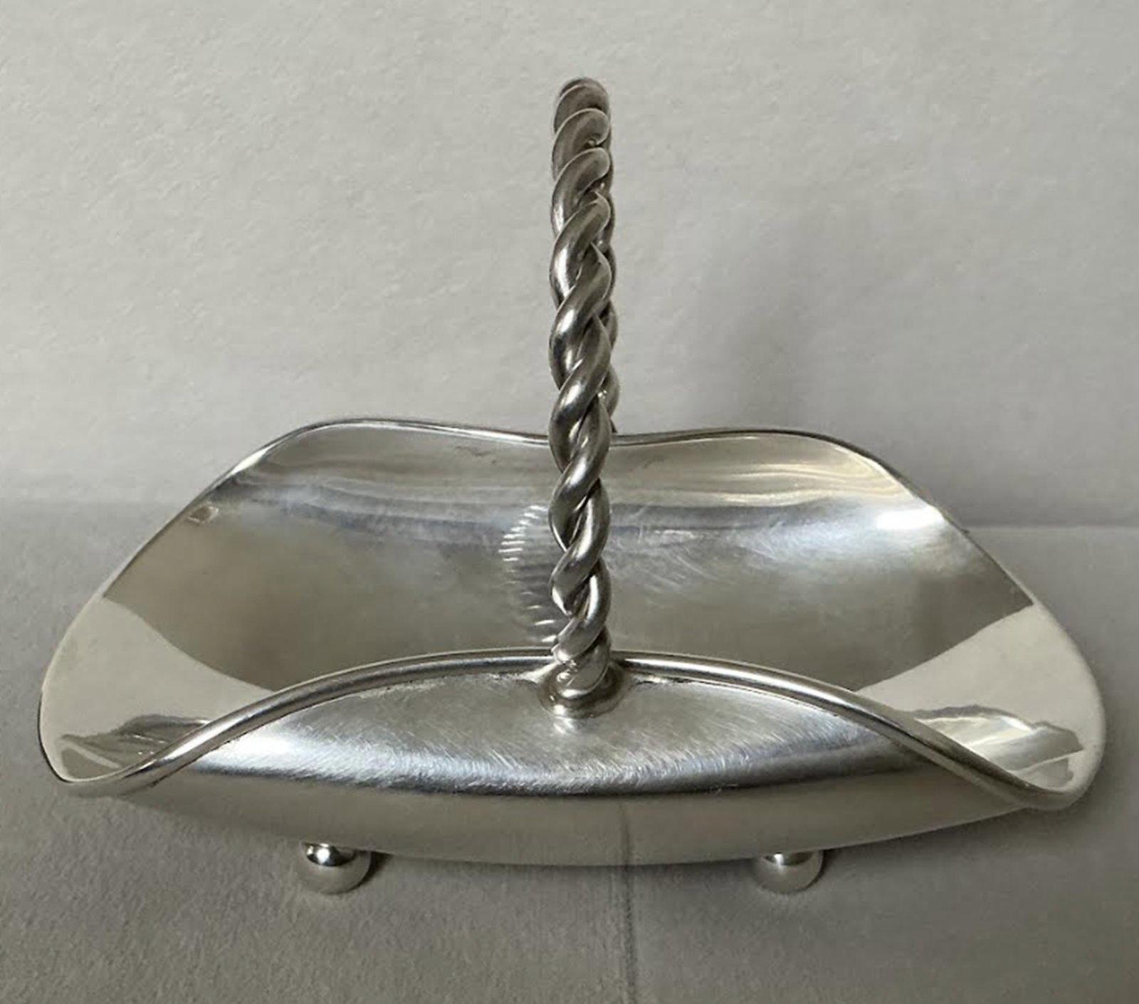 Cartier Sterling Silver Footed Trinket Baske with Handle pattern 101: Cartier Sterling Silver Footed Trinket Baske with Handle. Measures approx 5 inches across Makers mark on bottom 101