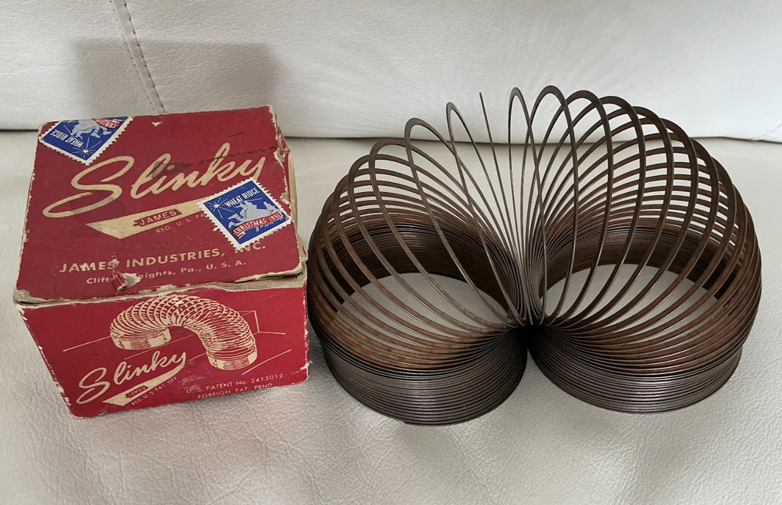 Original Slinky James Industries Walking Metal Toy Red w Original Box 1947: Original Slinky James Industries Walking Metal Toy Red w Original Box 1947. Original Slinky metal toy, manufactured by James Industries in the United States. This classic toy features a red color and 