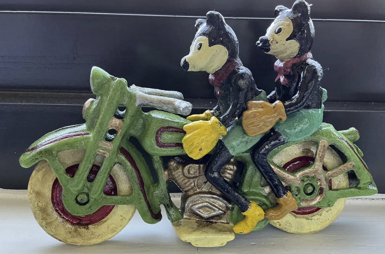 Cast Iron Mickey Mickey Mouse On Motorcycle: Cast Iron Mickey Mickey Mouse On Motorcycle Cast iron. Repro Collection Bike painted Red / Green with White wheels.The bike wheels turn.Measures approx. 10cm tall, 7cm wide, by 16cm deep.