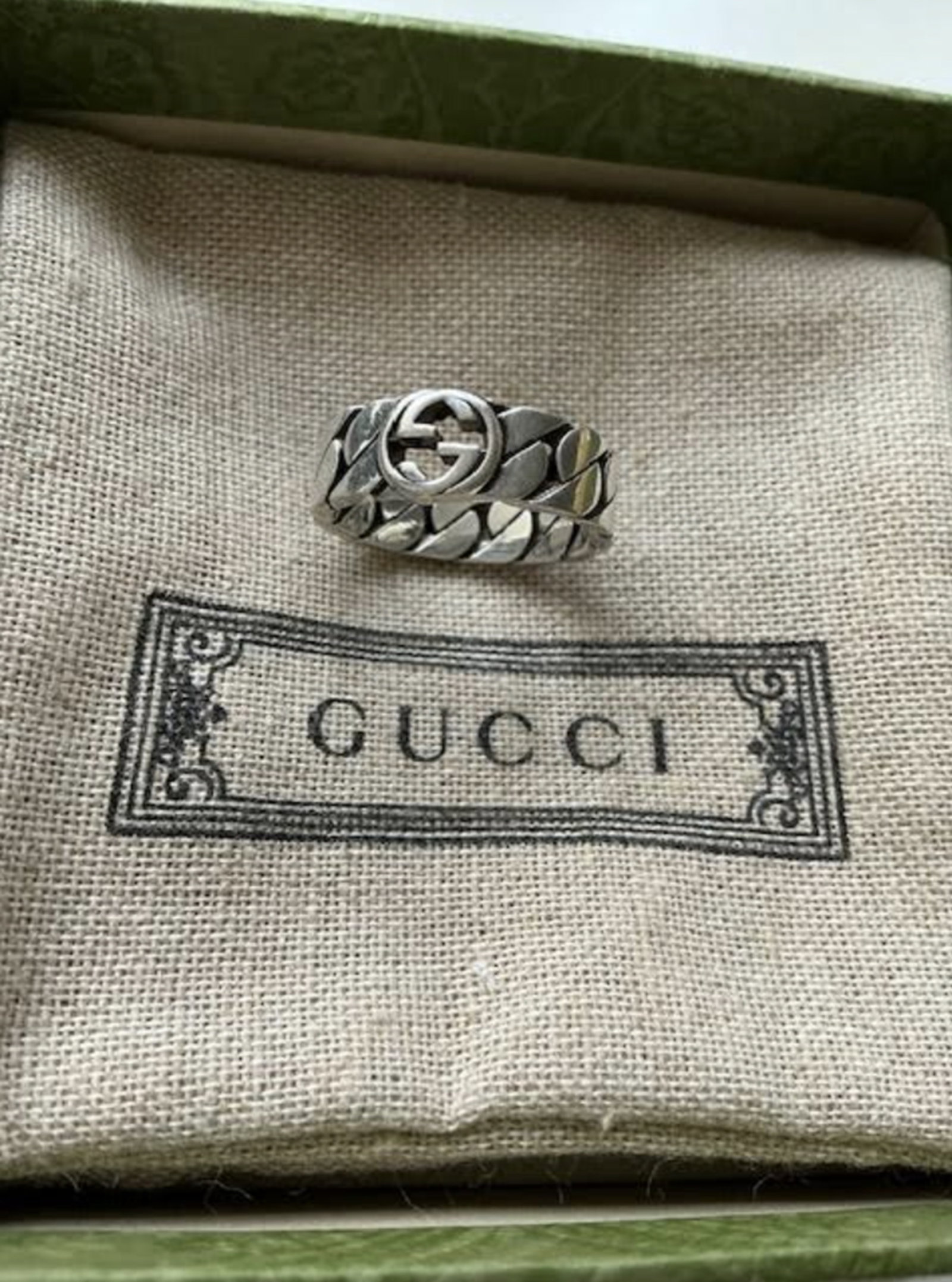 Gucci Sterling Silver Interlocking Ring With Orig Box: Gucci Sterling Silver Interlocking Ring With Orig Box. Made in Italy, this ring from Gucci is crafted of sterling silver and features an interlocking logo design.Sterling silverMade in Italy Ring