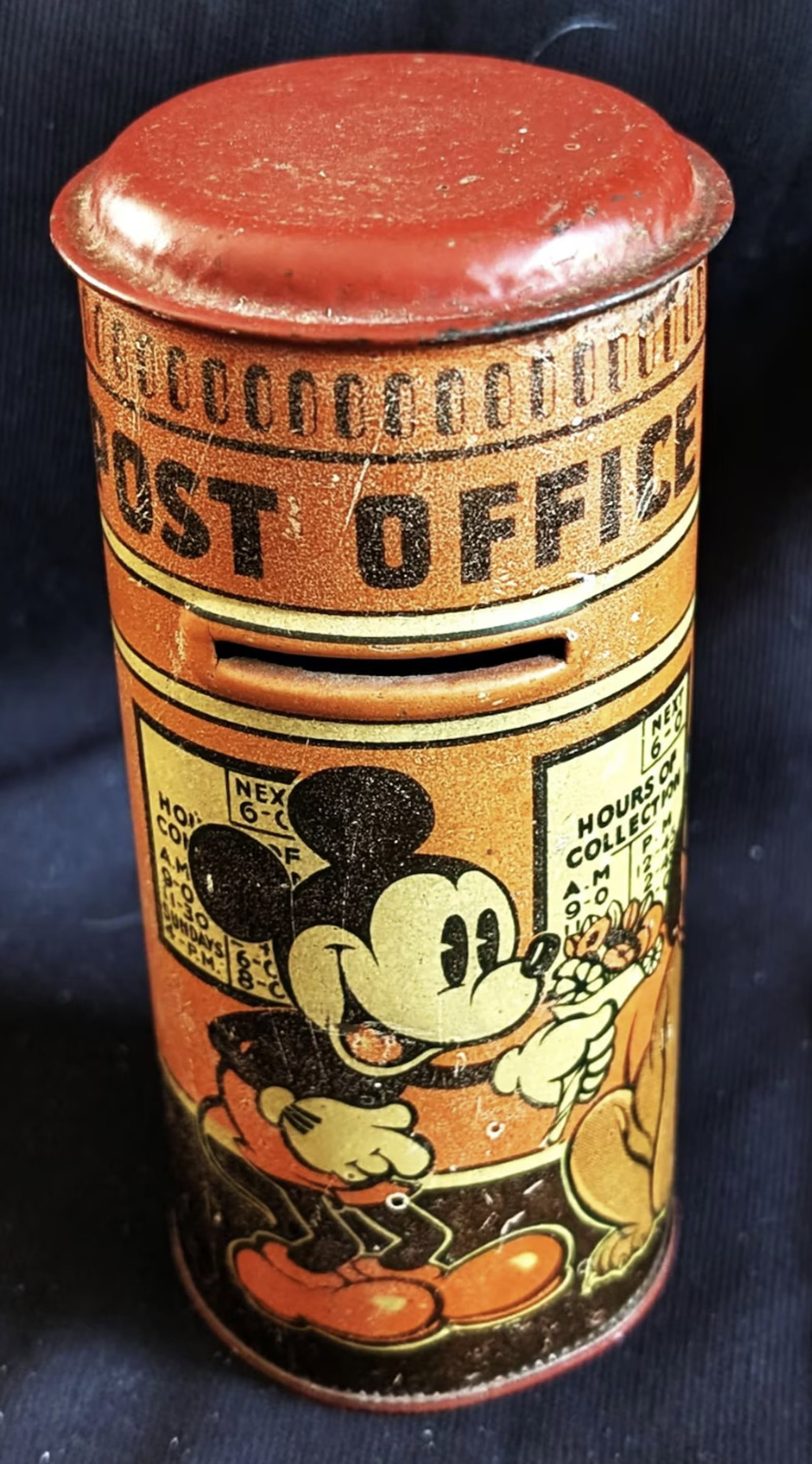 WALT DISNEY Mickey & Minnie and Pluto British tin postal-pillar bank. "Happynak" 1930's: WALT DISNEY Mickey & Minnie and Pluto British tin postal-pillar bank. "Happynak" 1930's. 6" tall, 2 3/4" across. Pretty good shape for something approaching 100 years old. ne minor dent at the