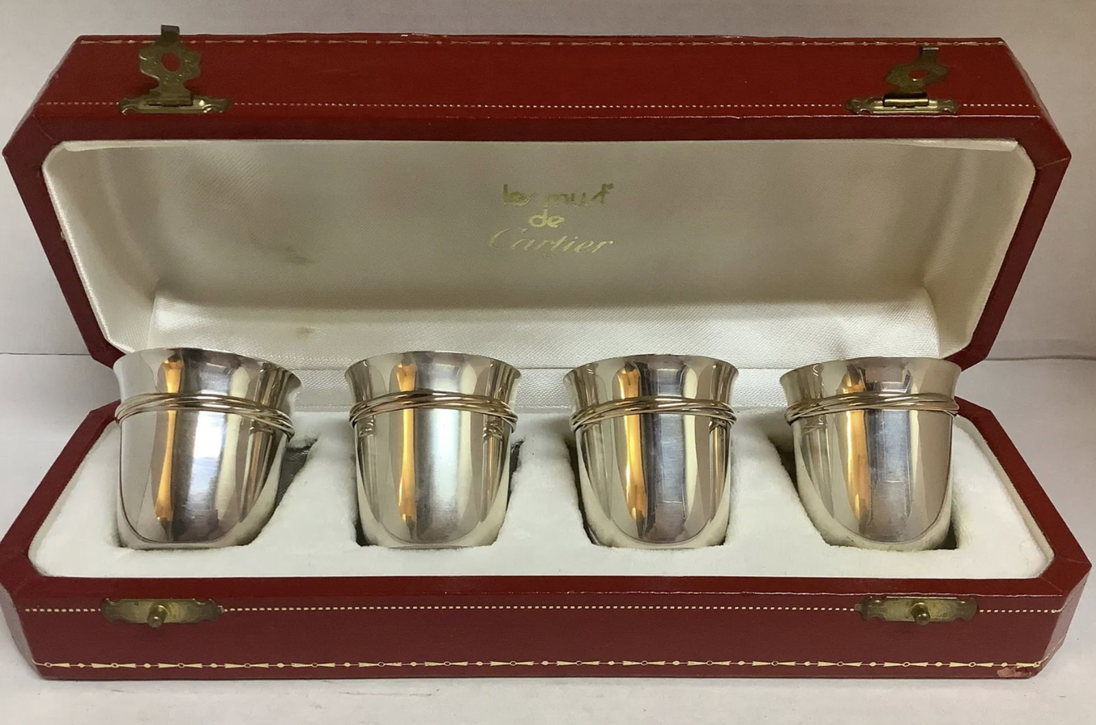 Cartier Sterling Silver Trinity Cup Set of 4 with Original Box: Cartier Sterling Silver Trinity Cup Set of 4 with Original Box Designed by Louis Cartier with the development of the Trinity Ring in 1924. Made of .925 sterling silver, it has 3 entwined rings in of w