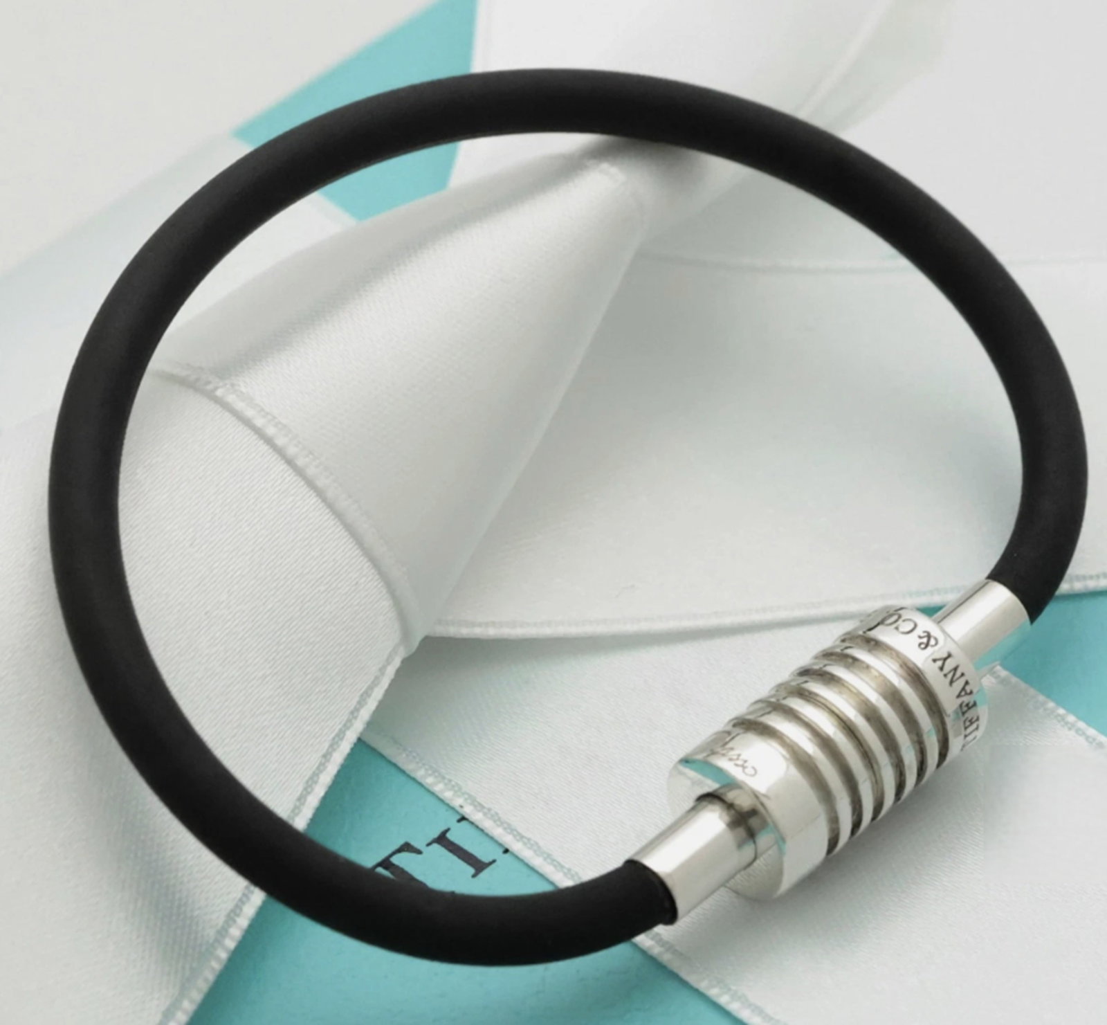 Tiffany & Co. Sterling Silver and Groove Rubber Cord Surfer Bracelet With Pouch: Tiffany & Co. Sterling Silver and Groove Rubber Cord Surfer Bracelet Measures approx 5.7 inches With Pouch