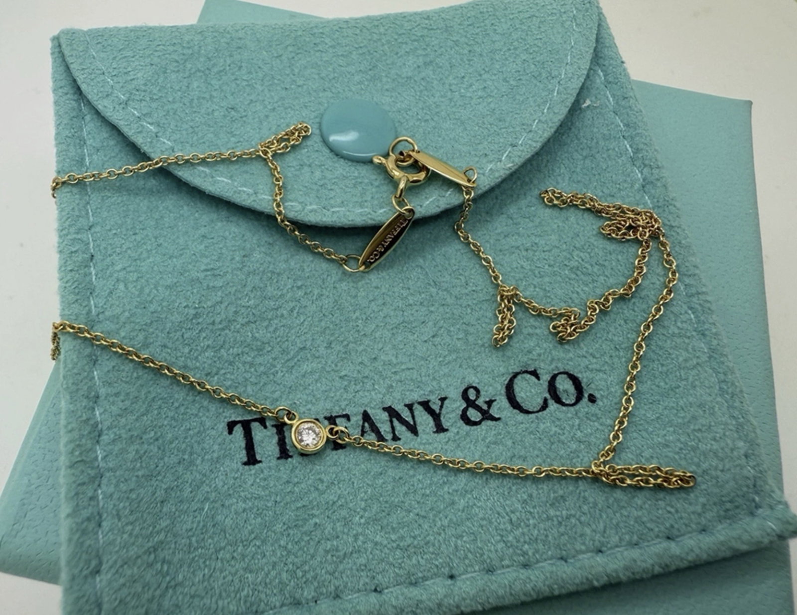 Tiffany Co 18k Yellow Gold Elsa Peretti Diamond by the Yard Necklace 16" With Pouch: Tiffany Co 18k Yellow Gold Elsa Peretti Diamond by the Yard Necklace 16" With Pouch. Tiffany Co 18k yellow gold Elsa Peretti Diamond by the Yard Necklace 16"Length: 16"Diamond size: approximately 0.06