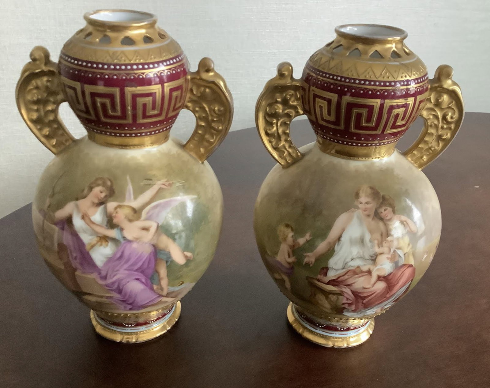 Royal Vienna Handpainted Cherub Pair of Porcelain vase urn with Makers mark: Royal Vienna Handpainted Pair of Porcelain vase urn with Makers mark Measures approx 7.5 inches tall 4 inches at widest point