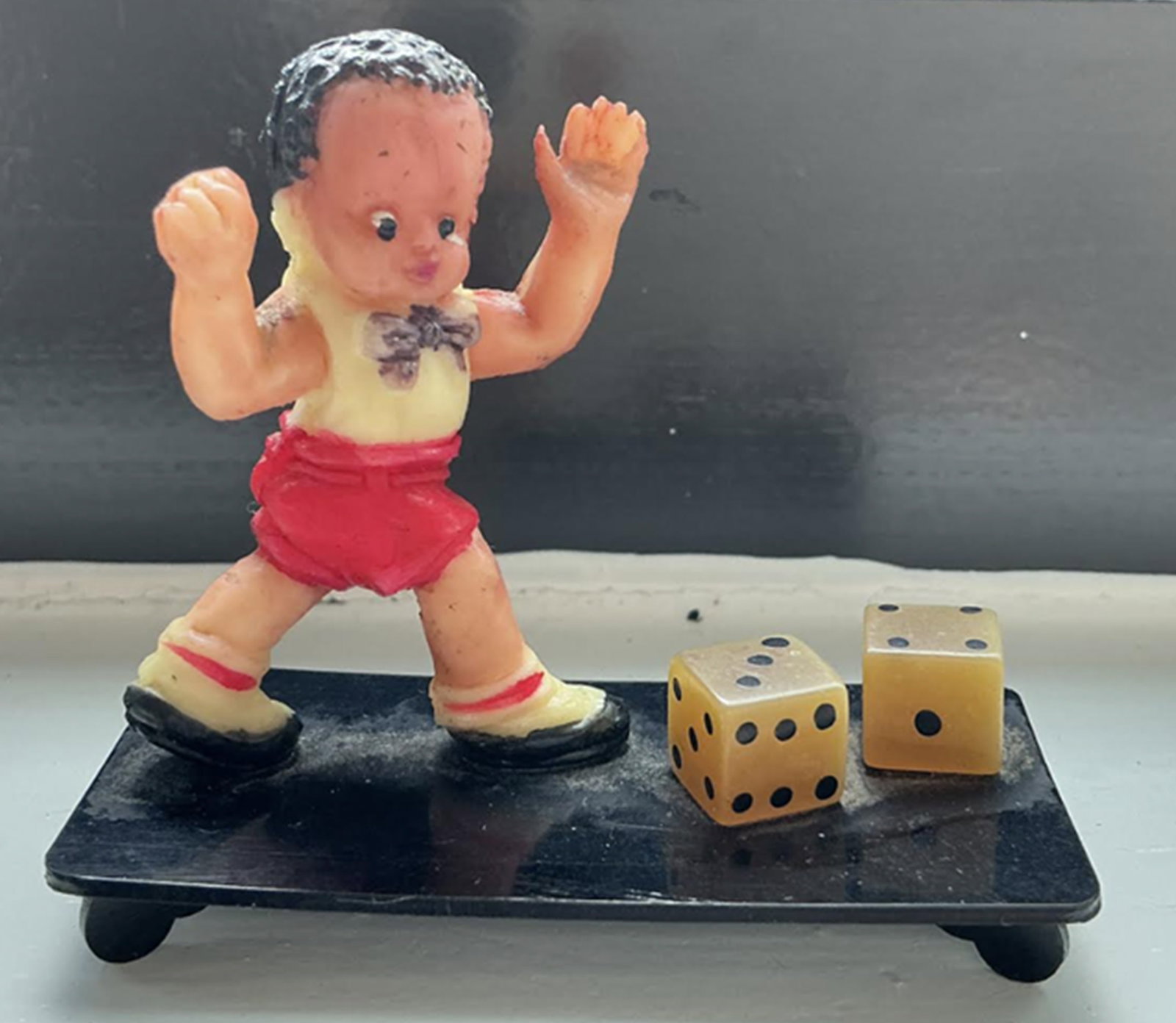 Japanese Celluloid Hand painted Boy Gambling with Dice Figurine Made in Japan: Japanese Celluloid Hand painted Boy with Dice Figurine Made in Japan. Measures approx 2.25 inches wide x 1 3/4 inch tall made in Japan