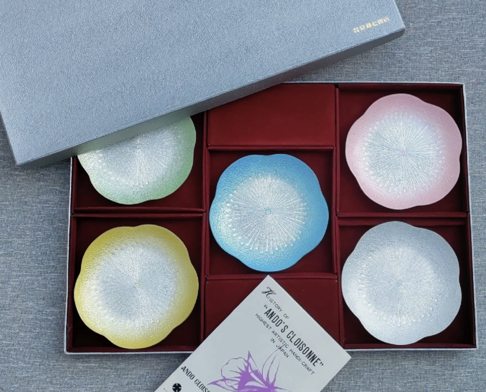 Japanese Cloisonne Enamel Dishes/Plates New In Original Box: Japanese Cloisonne Enamel Dishes/Plates New In Original Box. On the back of each dish there is a label that is marked Ando Cloisonne. They are flower shaped and come in pastel colors of green, yellow,