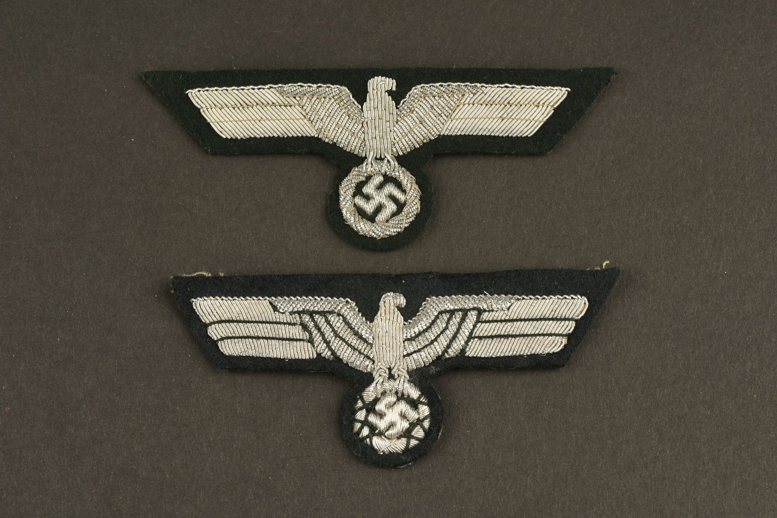 Aigles de poitrines d officier des services: Deux modeles differents d aigles d officier des services administratif de la Kriegsmarine. En cannetille argent, jamais montes. A noter une legere usure et patine des pieces. Two different models of K