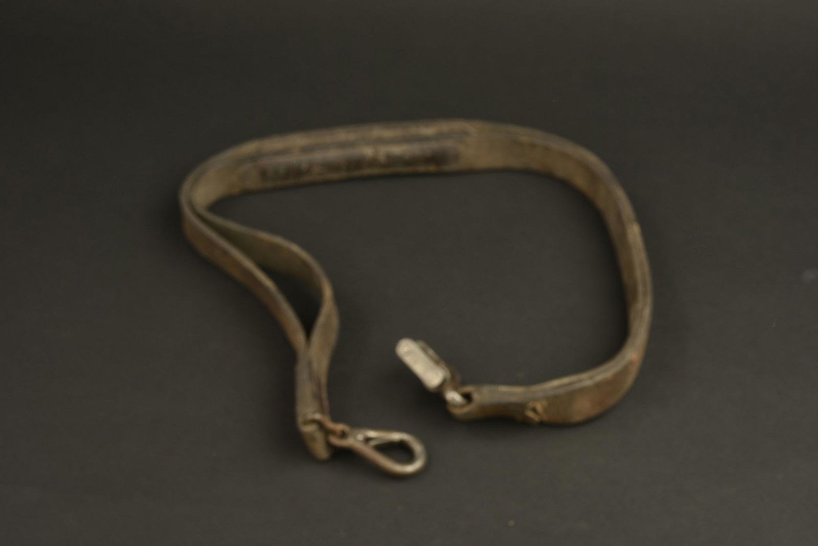 Bretelle MG. MG strap.: Bretelle MG. En epais cuir marron. Mousqueton complet et fonctionnel. Piece de fixation a la mitrailleuse en tres bon etat. Sans marquages visibles. A noter une certaine usure et patine de la piece. E