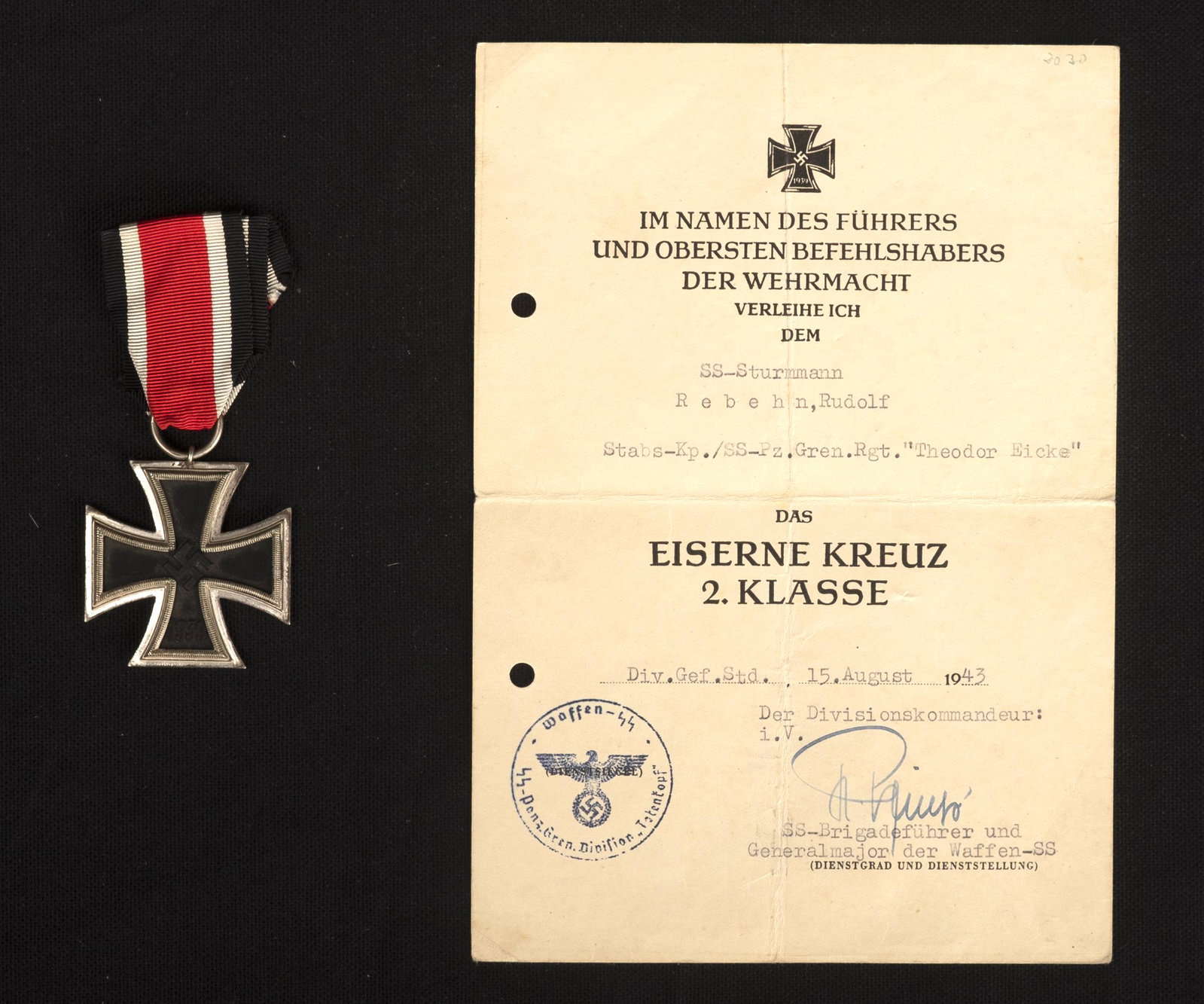 EK II avec diplome. EK II with diploma.: Croix de fer de seconde classe avec diplome. Comprenant un diplome en papier, deux perforations sur le cote gauche. Attribue au SS Sturmmann Rebehn Rudolf, du Stabs Kp SS Pz Rgt Theodor Eicke, en date