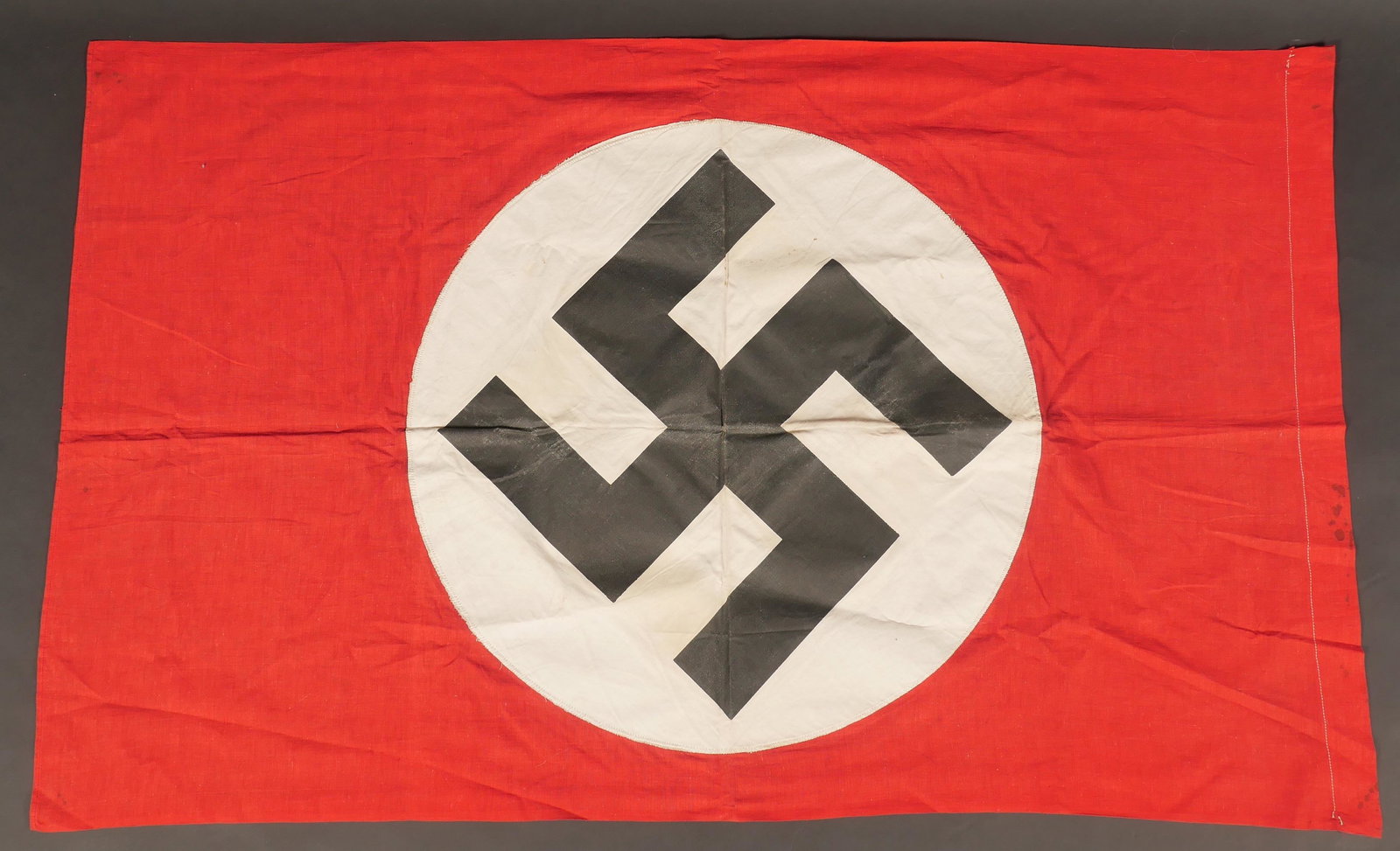 Drapeau allemand. German flag.: Drapeau allemand. En tissu coton rouge. Partie centrale rapportee, embleme national imprime sur une toile impermeabilisee. Biface. Sans marquages visibles. Dimensions 67 x 112 cm. A noter une certaine