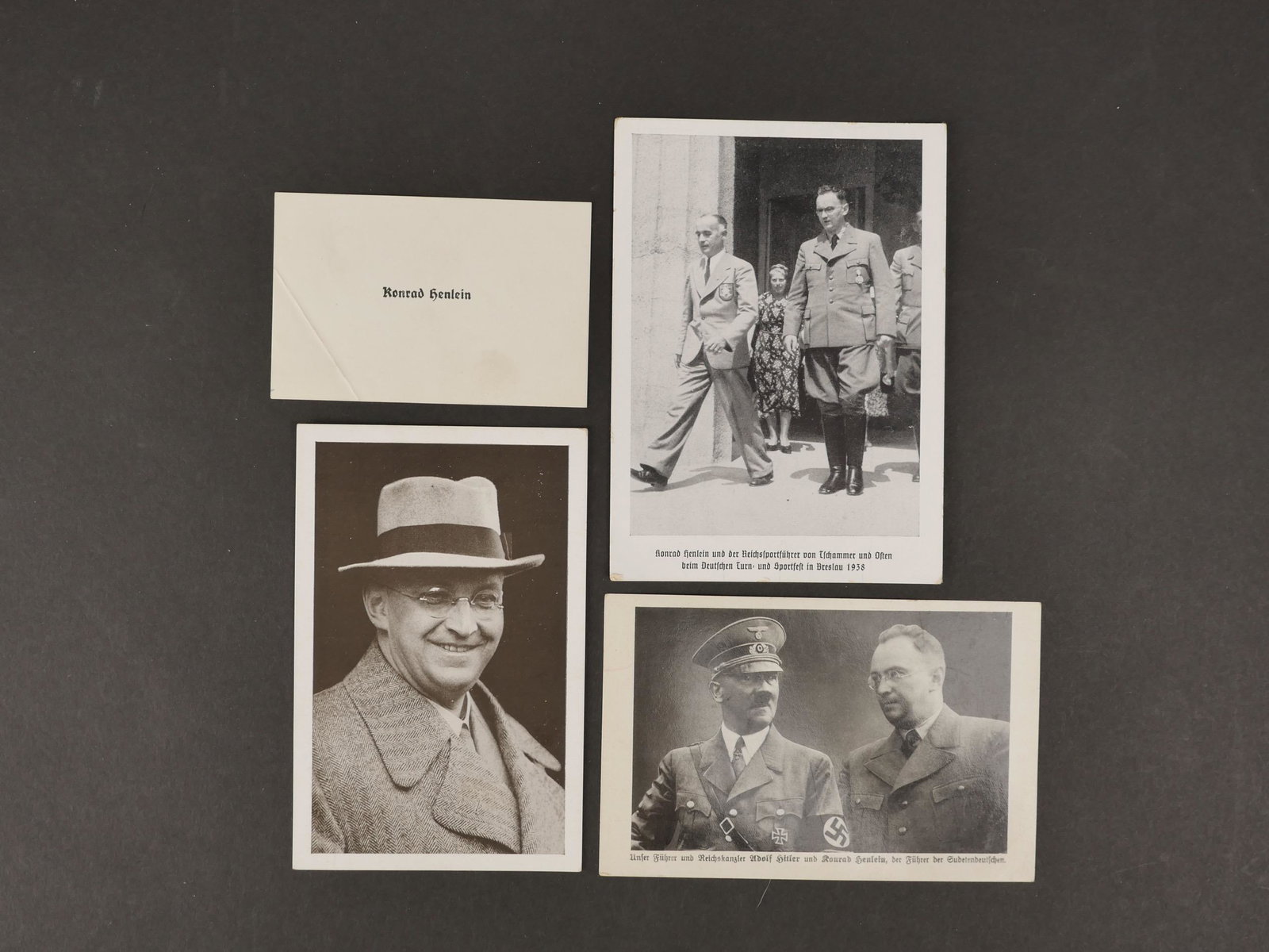 Une carte de visite originale de Konrad Henlein. An original business card from Konrad Henlein.: Une carte de visite originale de Konrad Henlein. Format 8x10 cm, vierge a son nom imprime en noir. On y joint trois cartes postales ayant voyagees le representant. Quelques salissures et manques. An o