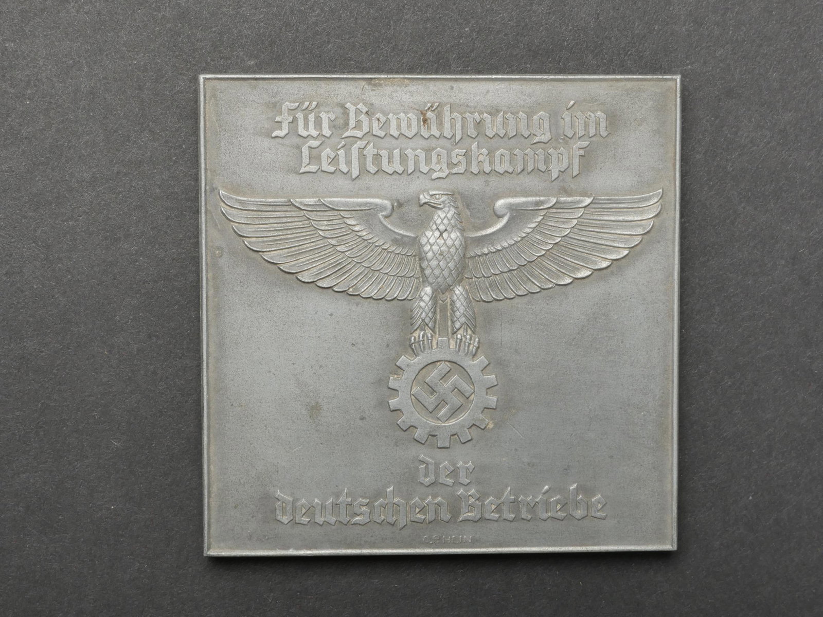 Plaquette DAF. DAF Plate.: Plaquette du DAF. En metal, decors en relief. Bel aigle et insigne du DAF. Marquages au recto Fur Bewahrung im Leistungskampf der Deutschen Betriebe. Fabrication C R Hein. Au verso Derliehen von der D