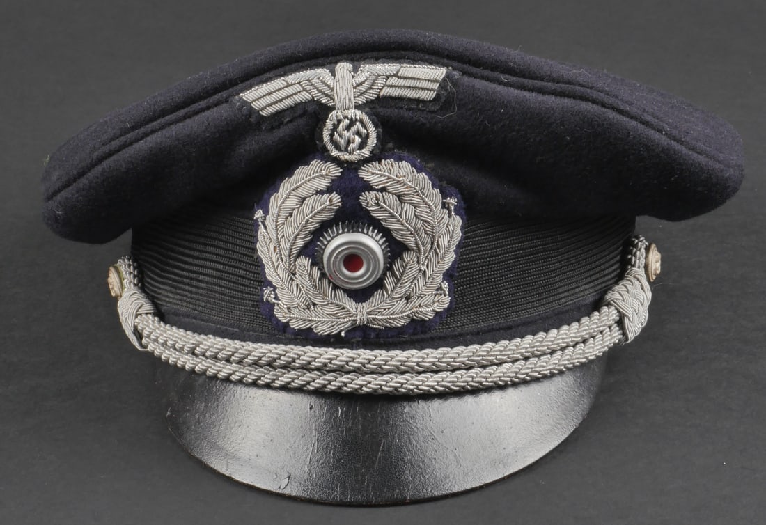 casquette administration KM. Kriegsmarine administration cap.: casquette d'officier de l'administration de la Kriegsmarine. En drap bleu marine. Visiere en cuir souple. Bandeau en mohair noir. Aigle et feuilles de chene en cannetille argent. cocarde metallique. L