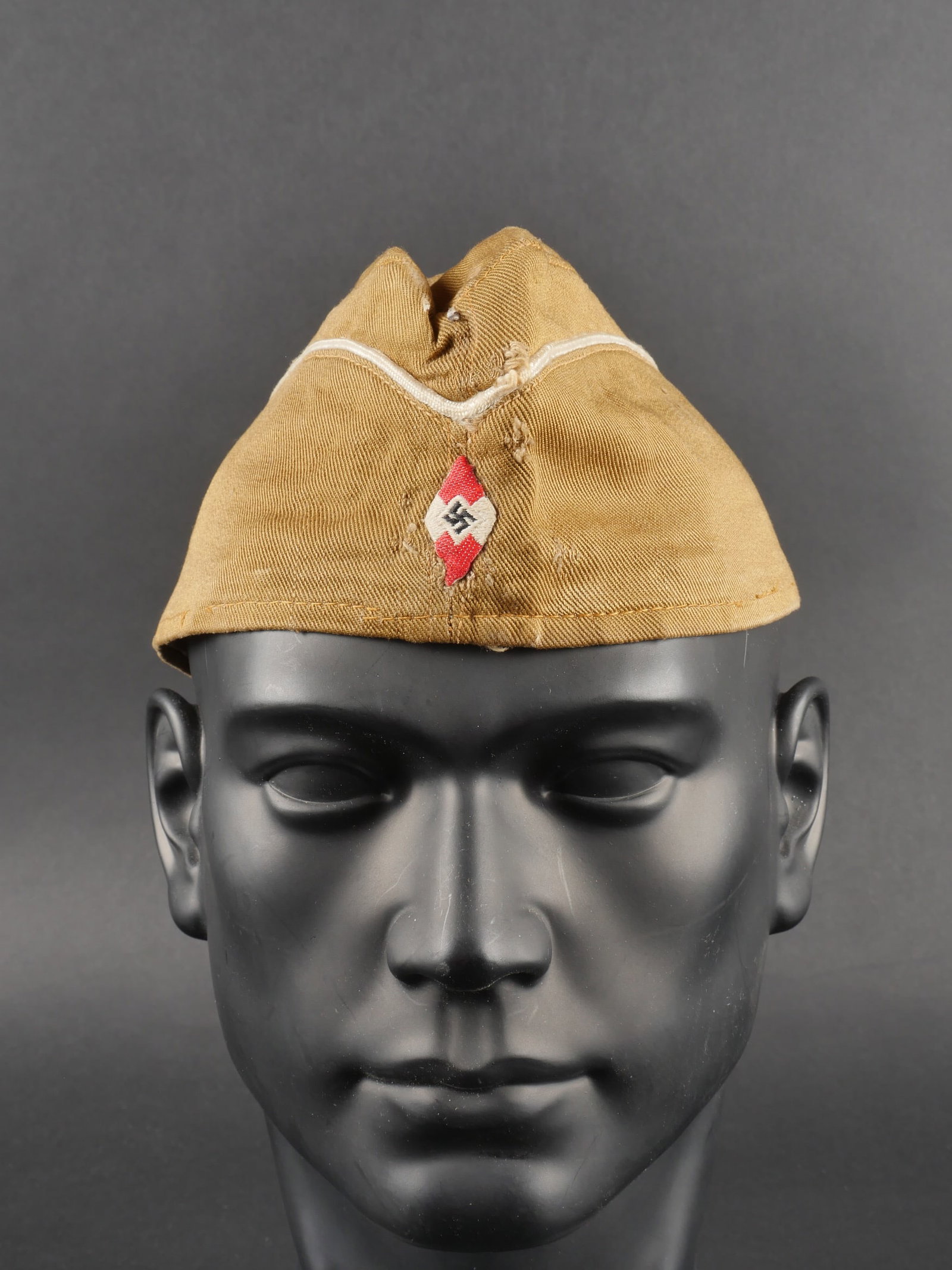 Calot Hitlerjugend. German Hitlerjugend cap.: Calot Hitlerjugend. En tissu soyeux beige. Lisere blanc faisant le tour de la coiffure. Insigne tisse Hitlerjugend, visiblement monte d origine. Interieur double en tissu beige. Etiquette RZM partiell