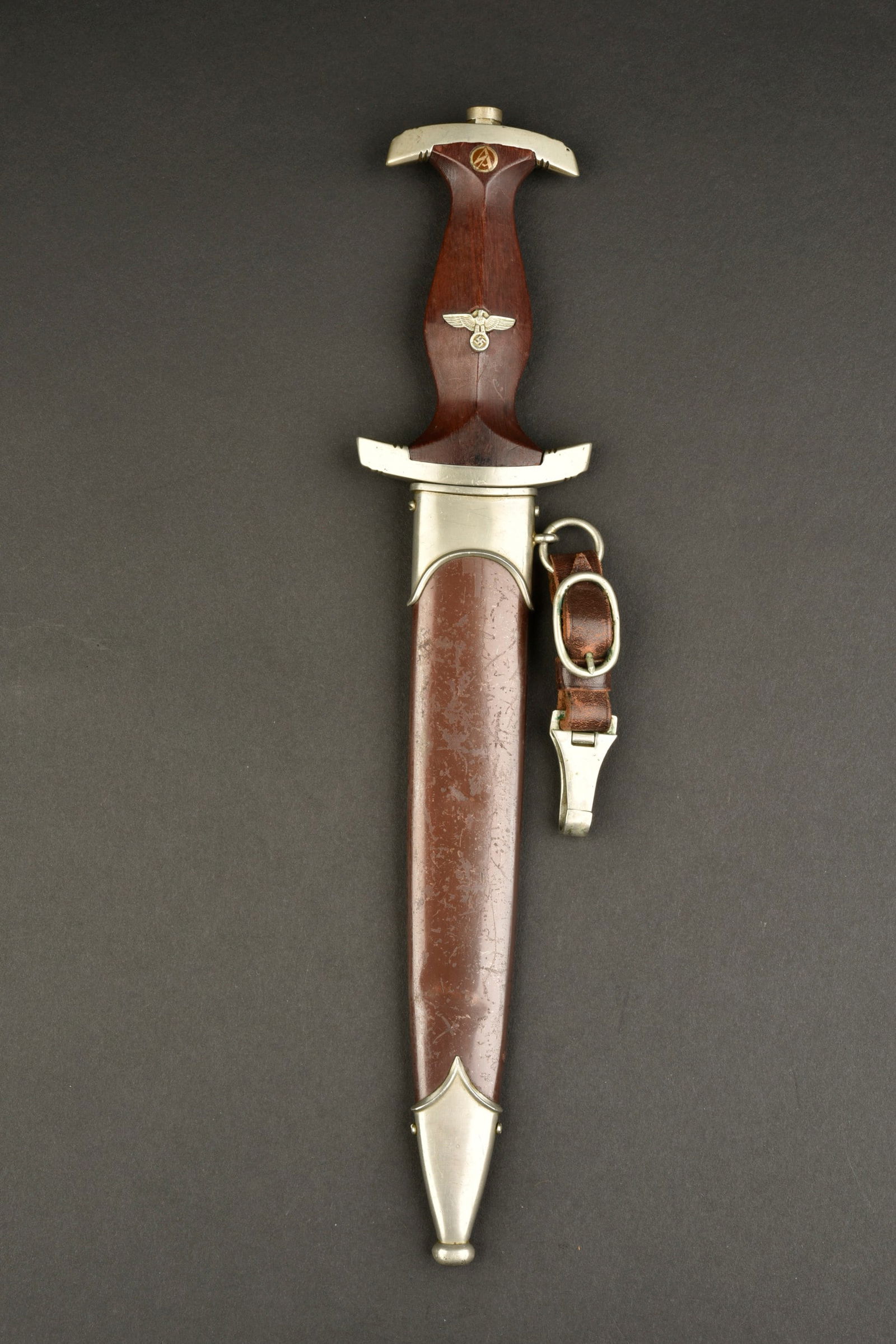 Dague SA. SA Dagger: Dague SA. Poignee en bois marron. Toutes les garnitures sont en metal. Insigne SA etaigleallemand montes d origine. Garde marquee P. Belle lame presentant des marques d usures. Devisealles Für Deutsc