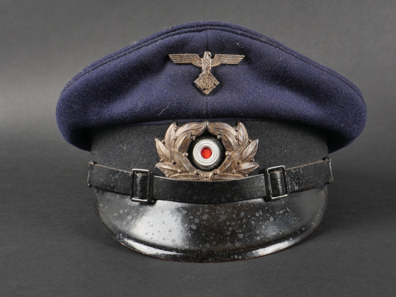 Casquette du Teno. German Teno cap.: Casquette du Teno. Modele pour sous-officier. En drap bleu marine. Insignes en metal du Teno. Les insignes n ont pas ete demontes afin de verifier les attaches. Fausse jugulaire en cuir noir. Bandeau 
