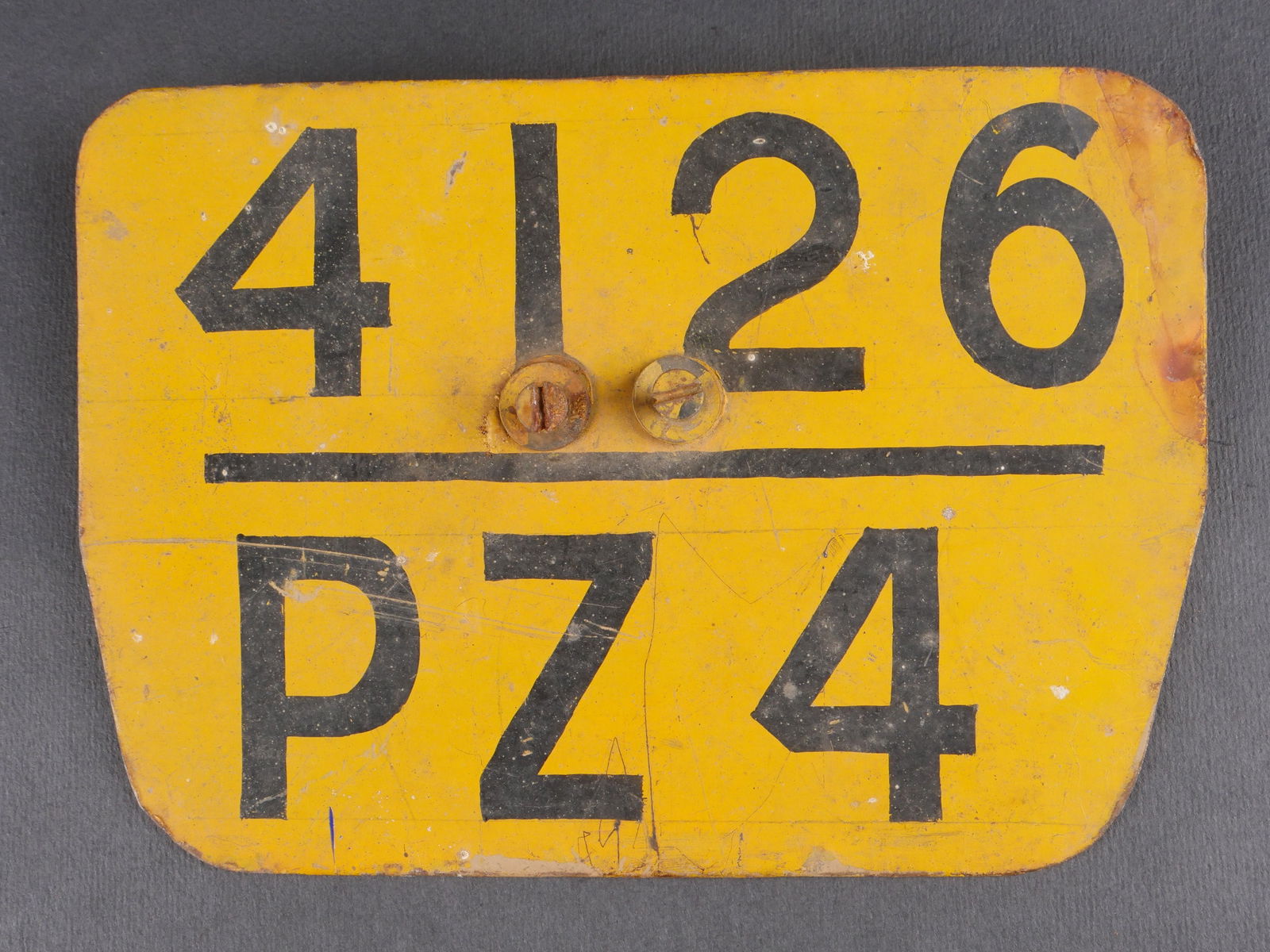 Plaque d immatriculation allemande. German Licence plate.: Plaque d’immatriculation allemande de type trapezoidal en metal, recouverte d’une peinture jaune uniforme. Marquages au pochoir et peinture noire 4126 PZ4. Deux vis de fixation avec ecrous present