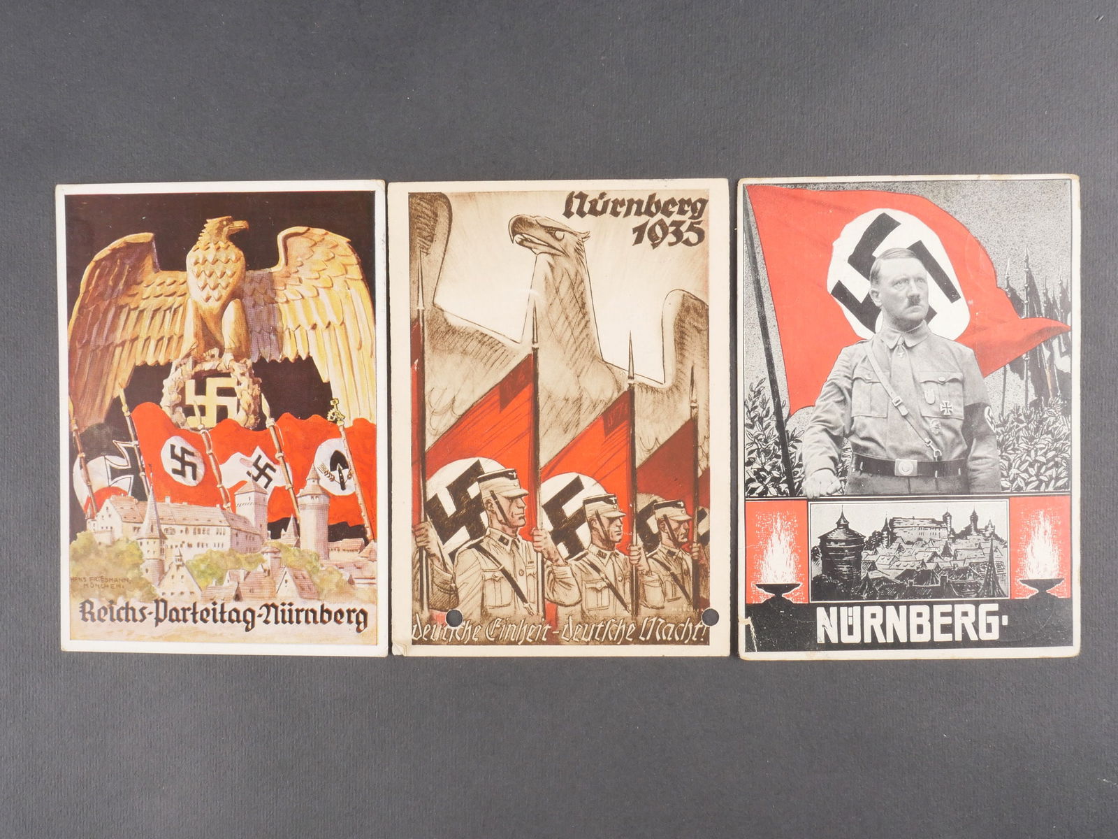 Cartes postales Reichsparteitag. Reichsparteitag Postal cards.: Trois cartes postales du Reichsparteitag, modeles differents, toutes avec texte manuscrit au dos. Modeles en couleur. Presente une certaine usure et patine. etat II+. Three different Reichsparteitag p