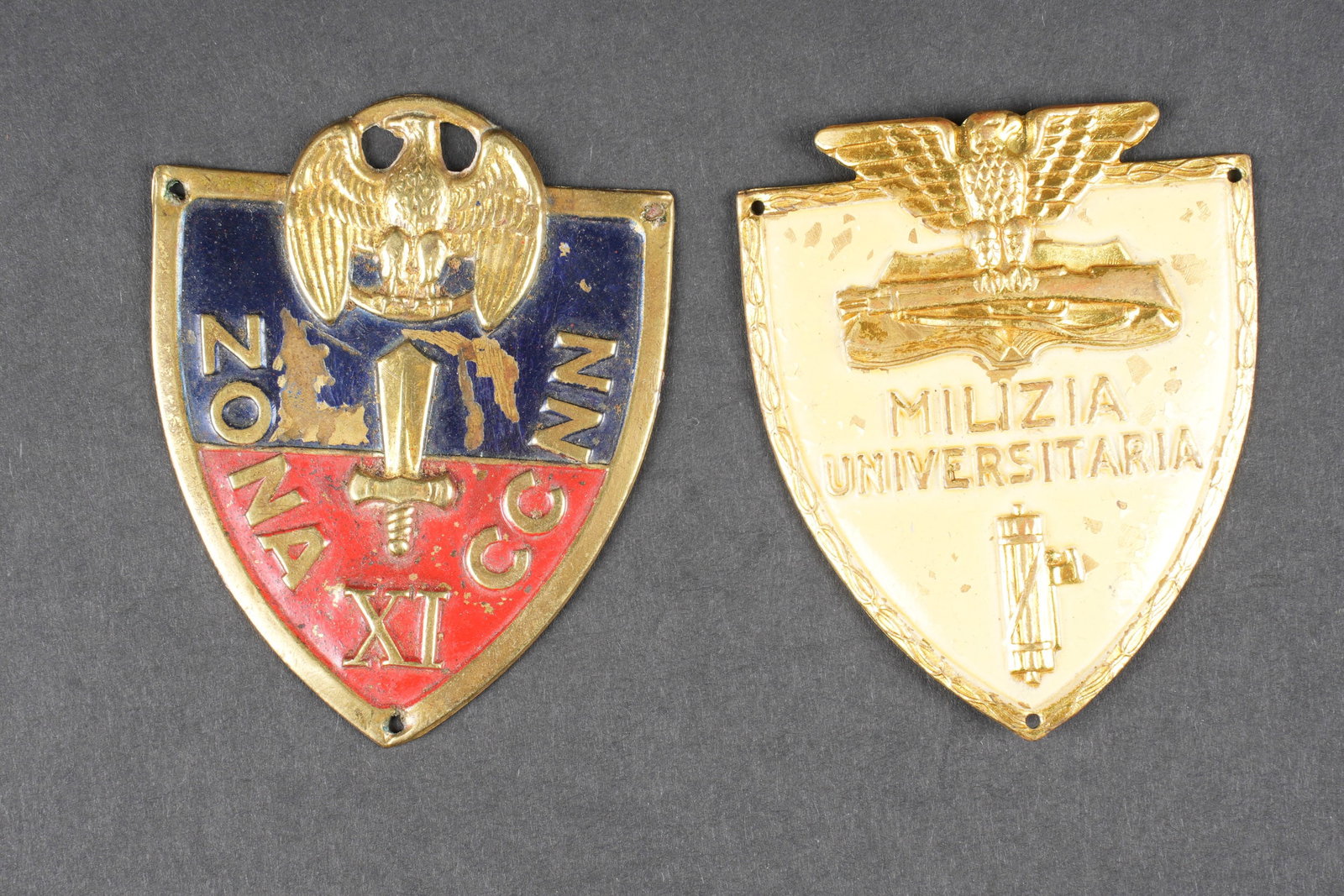 Insignes de manche MVSN. MVSN sleeve insignia.: Insignes de manche MVSN. Comprenant une plaque de manche de la 11eme legion, quelques manques de peinture au centre. Un plaque de manche de la Milizia Universitaria, quelques manques de peinture visib