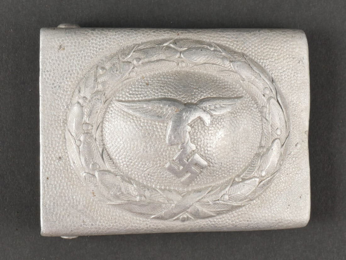 Boucle de ceinturon LW. Luftwaffe belt buckle.: Boucle de ceinturon Luftwaffe, en aluminium grenele. Aigle de la Luftwaffe du premier type. Boucle a deux ardillons complete. Les logos fabricant sont visibles. Modele Drop Tail. A noter une certaine 