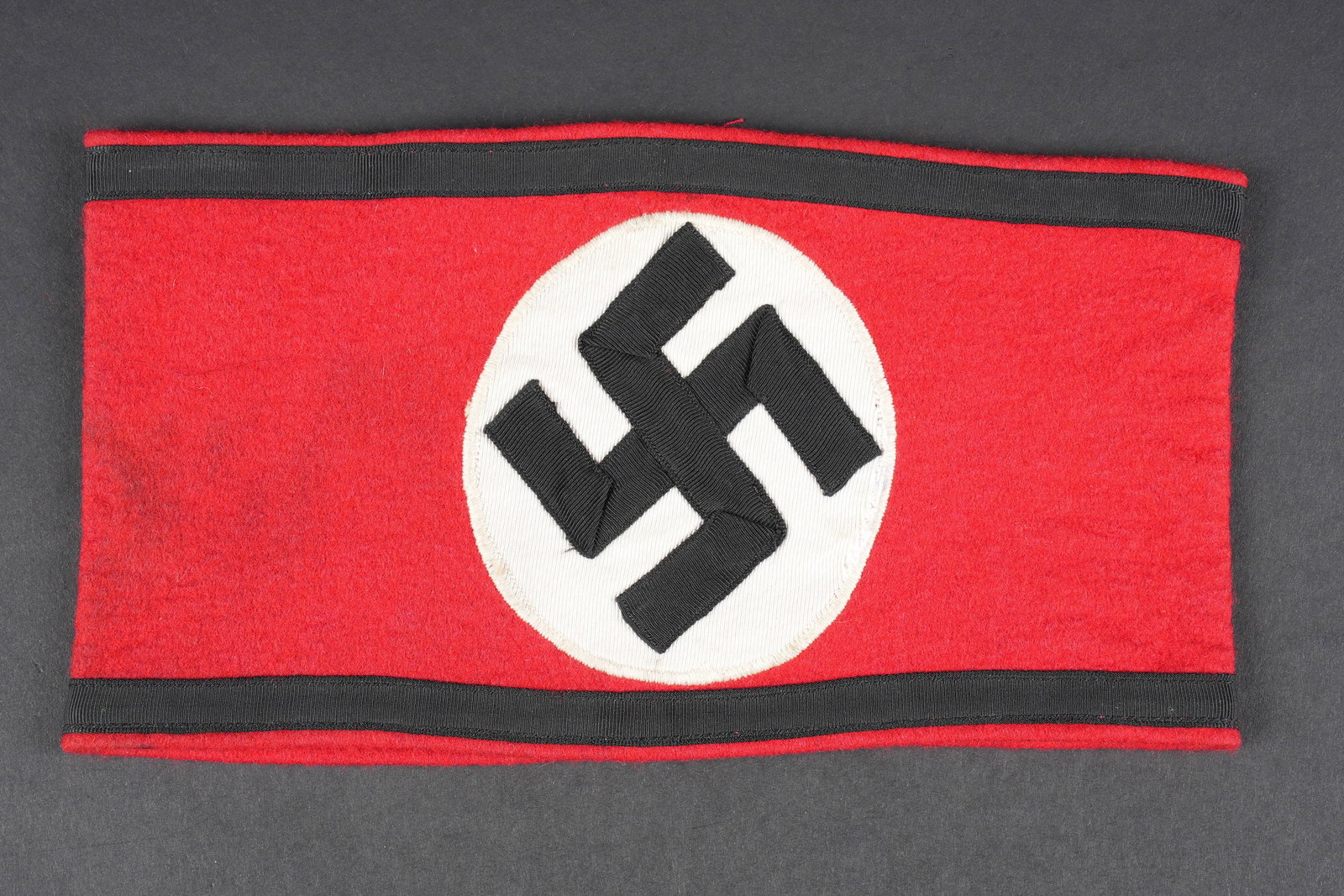 Reproduction brassard SS. Copy of SS armband.: Reproduction de brassard Allgemeine SS. Ancienne reproduction en drap. A noter une certaine usure et patine de la piece, ainsi que quelques taches. Etiquette RZM numero 204894, code fabricant 134. Eta