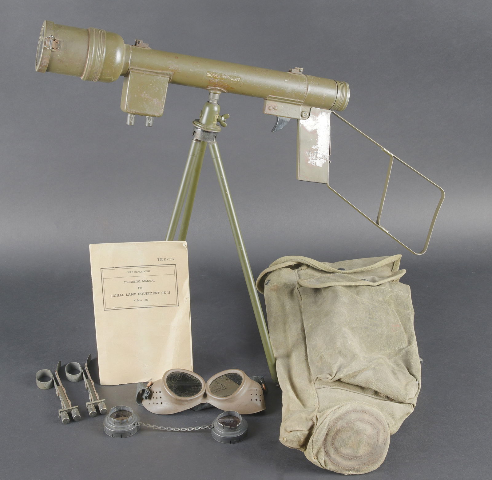 Lunette M-227. Sight M-227: Lunette M-227. Lunette en metal. Poignee de detente en bakelite noire. Filtre complet, ampoule presente, peinture kaki a 70%. Piles absentes. Marquages Signal AN M-227. Trepied LG-21 complet. Peinture