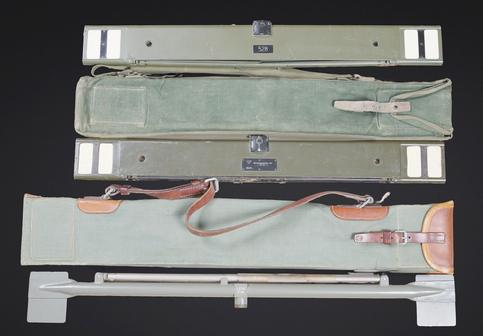 Regles de calcul. Slide rules: Regles de calcul. Comprenant une housse en tissu kaki, et cuir marron. La sangle de transport et la sangle de fermeture sont completes. Fabrication suisse. Instrument en metal, peinture grise a 100%.