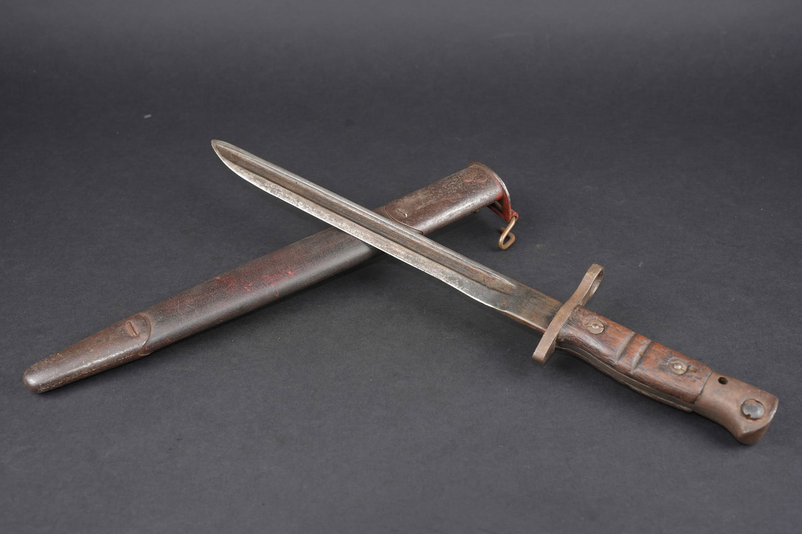 Baionnette US17 raccourcie. Shortened US M1917 bayonet.: Baionnette US17 raccourcie. Lame US17 du fabricant Remington, raccourcie a une longueur de 27,3 cm pour une longueur totale de l arme de 39,3 cm. Plaquettes bois striees. Bouton ressort a debloquer. D