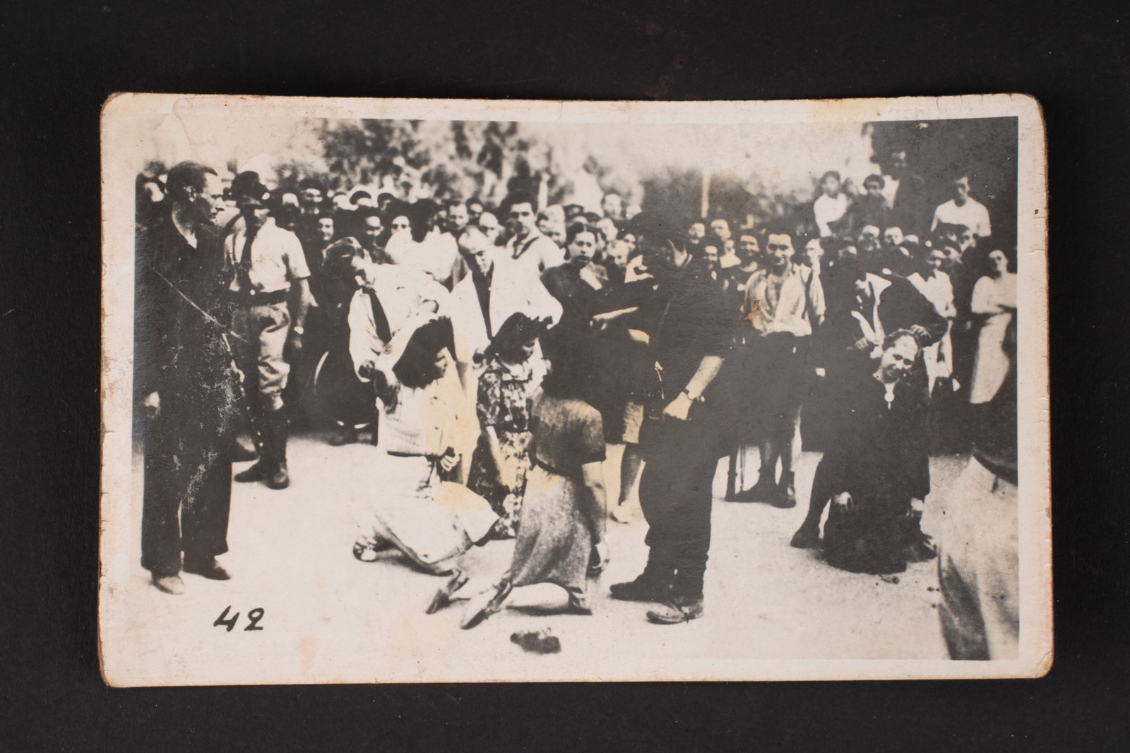 Photo de la Liberation. Liberation photograph.: Photo de la Liberation. Petit format 7 x 11,5 cm. Noire et blanc, representant des femmes se faisant tondre juste apres la liberation. Tampon au dos des Milices Patriotiques Groupe Dupuy. A noter une 