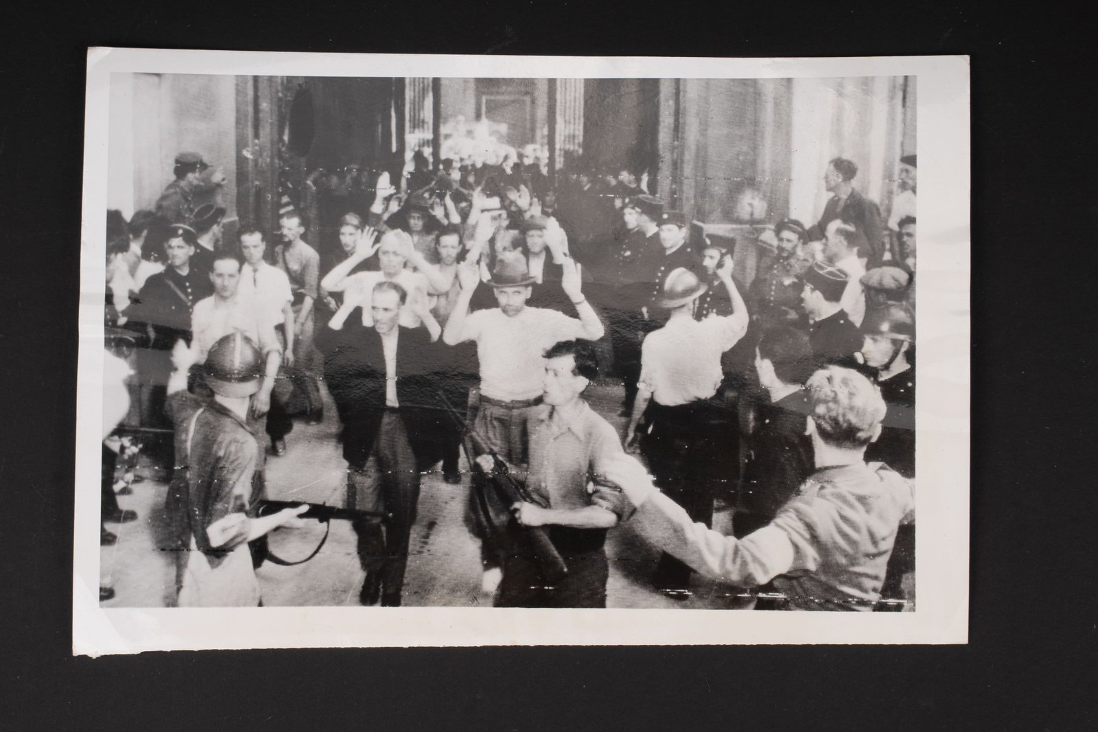Photo de presse FFI. FFI press photograph.: Photo de presse FFI. En noir et blanc, 15 x 23 cm. Intitulee Collaborationists on Parade France Armed Members of the French Forces of the interior march frenchmen accused of collaboration with the nai