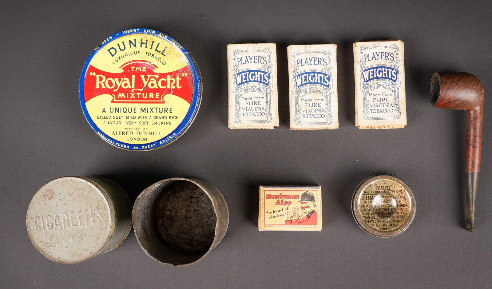Accessoires du fumeur britannique. British smoker’s accessories: Accessoires du fumeur britannique. Comprenant une boite en metal vide, marquee Cigarettes. Une boite en metal vide, marquee Dunhill The Royal Yacht. Une boite en metal vide, couvercle absent,