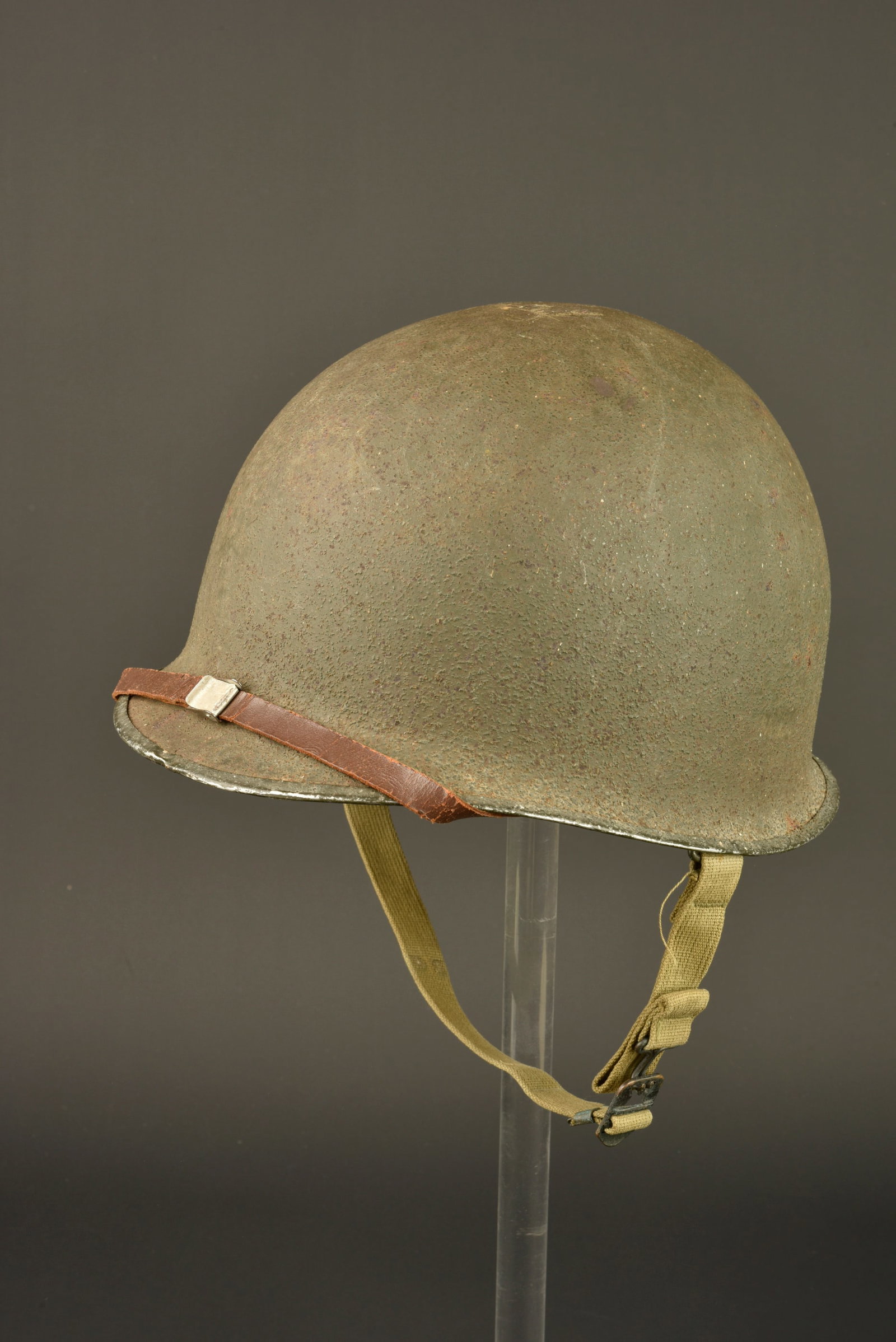 Caque USM1. USM1 Helmet: Casque USM1. Coque de casque USM1. Fermeture du jonc a lavant. Numero de lot 286C. Pontets fixes. Jugulaires completes mais vraisemblablement posterieure. Peinture et cork a 85%. Liner en materiaux co
