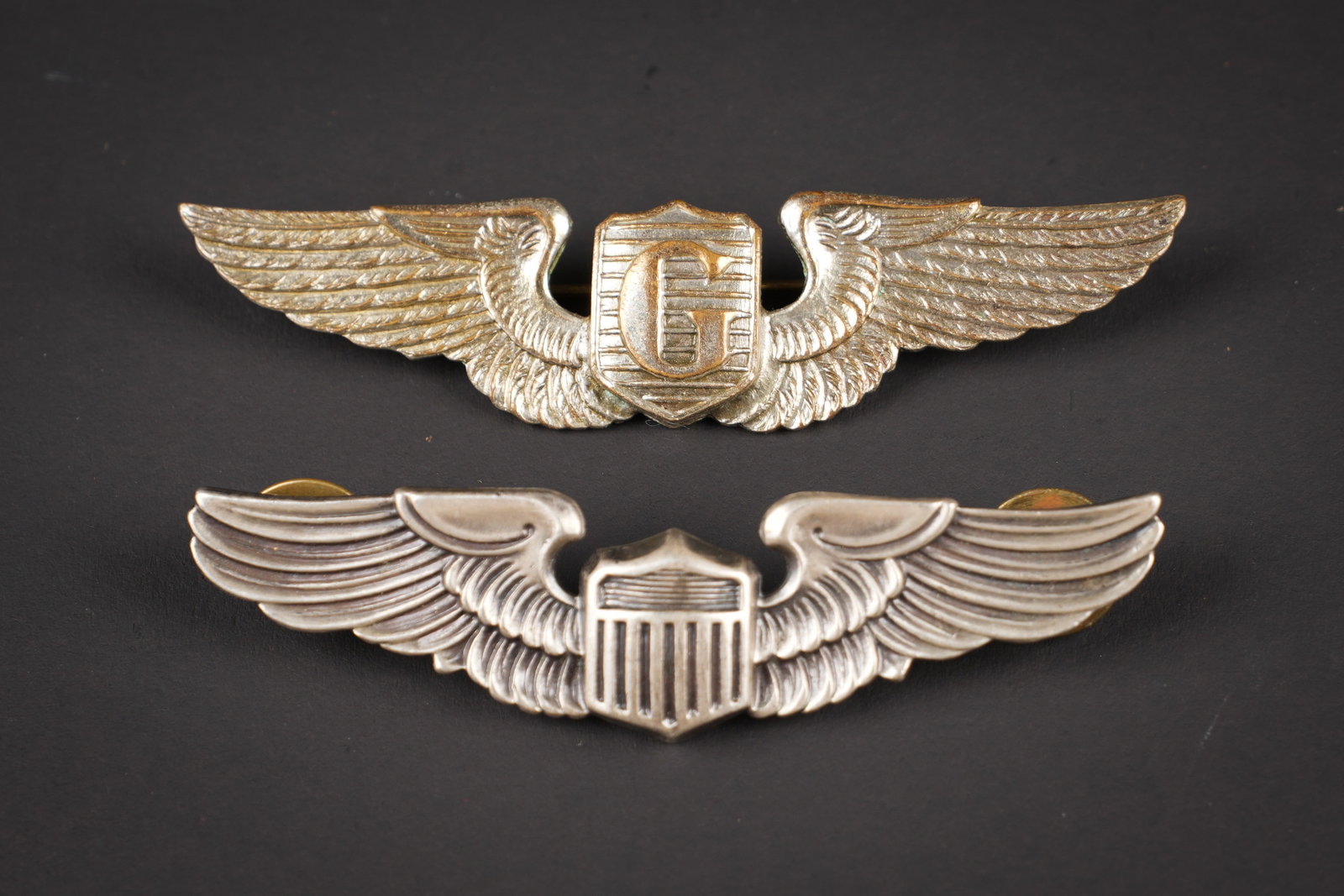 Brevet de pilote US. US pilot wings.: Brevets de pilote US. Comprenant un brevet de pilote, couleur argent, marquages Sterling Vanguard NY, attaches completes. Un brevet de pilote Glider, couleur argent, sans marquages. Attache complete. 