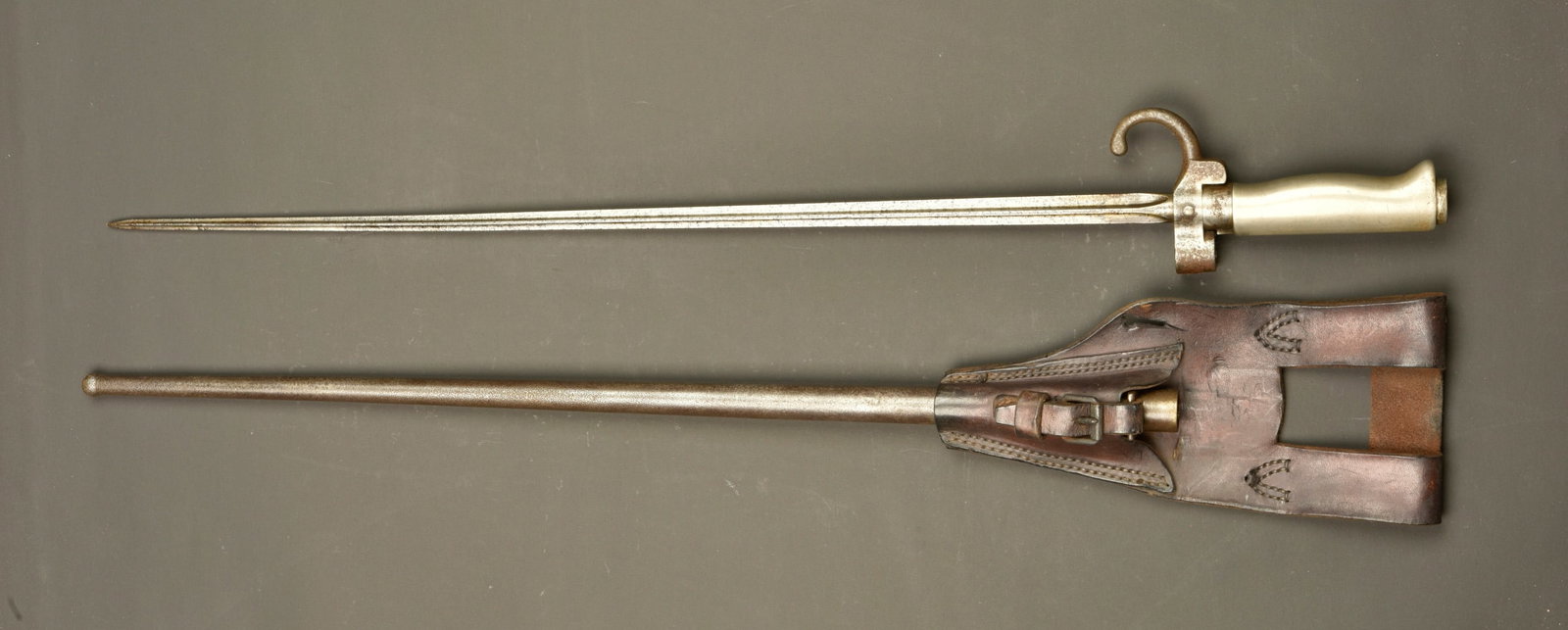 Epee baionnette Lebel 1886 avec porte fourreau. Lebel Model 1886 sword bayonet with frog: Epee baionnette Lebel 1886 avec porte fourreau. Lame cruciforme, poignee maillechort, croisiere avec quillon, bouton ressort fonctionnel. Fourreau fer, numero different de celui de l arme. Porte fourr