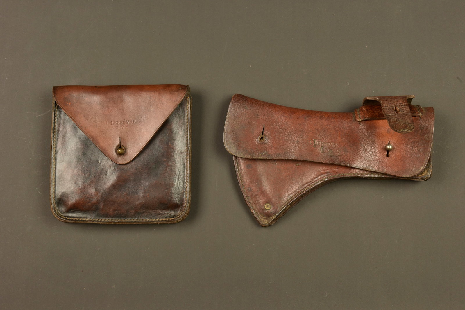 Outillage francais etui de hache et scie pliante. French tool equipment set with axe carrier and: Outillage francais etui de hache et scie pliante. Bel etui en cuir pour la hache, fabricant Lefebvre 1917 avec plusieurs matricules, etui vide. Etui pour scie pliante en cuir marron, fabricant Lefebvr