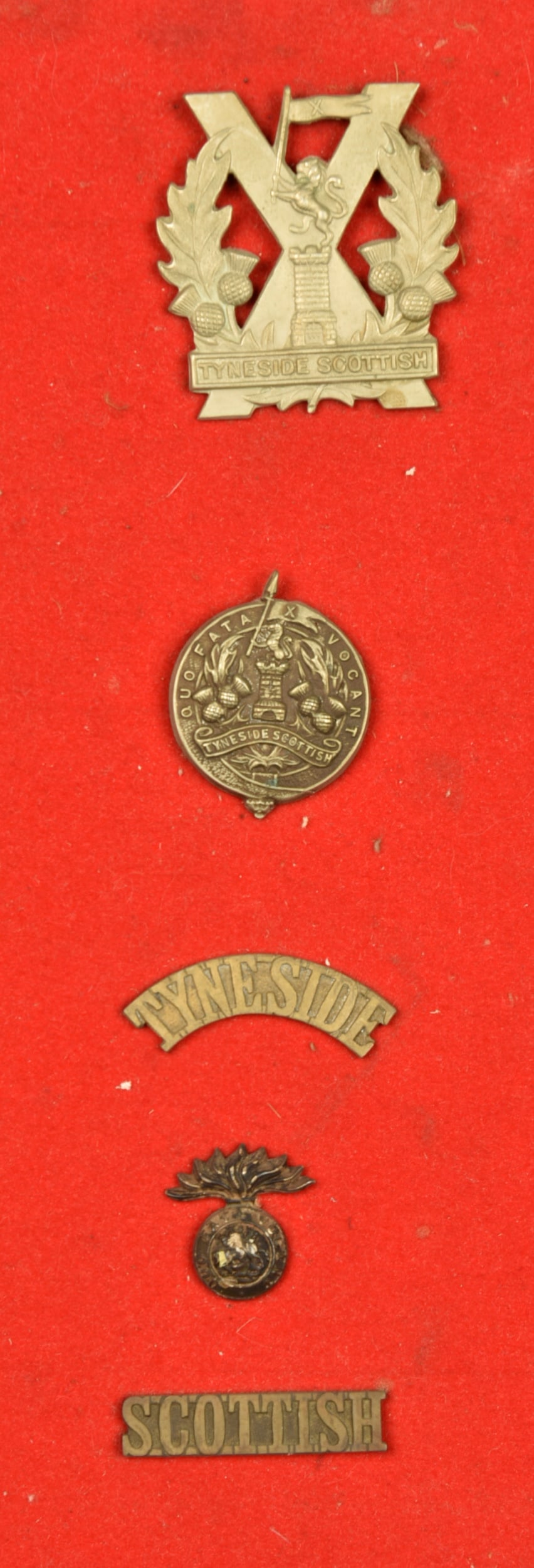 Ensemble d insignes des Tyneside Scottish. Badge grouping of the Tyneside Scottish: Ensemble d insignes des Tyneside Scottish. Comprenant le cap badge rond du 1er type porte de 1914 a debut 1915, un cap badge, et 3 elements d insigne d epaule. Avec leurs attaches. Bel ensemble, patin