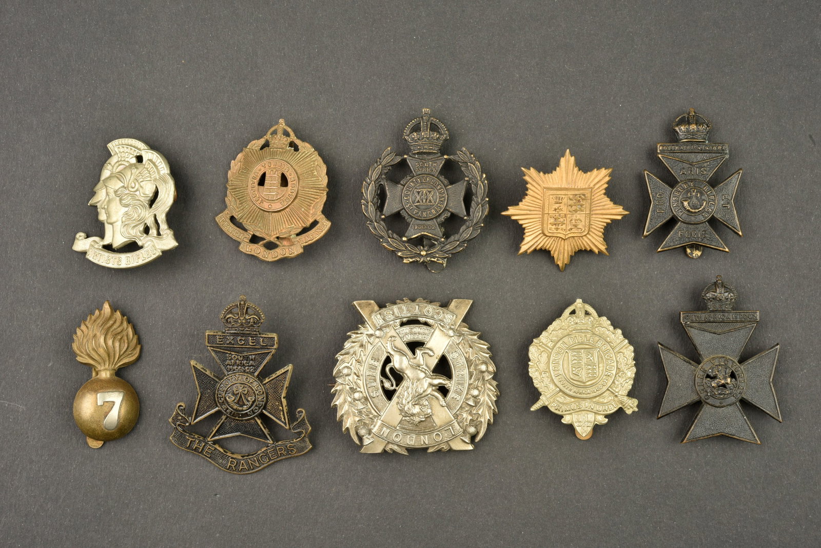 Lot de 10 insignes de regiments de Londres. Lot of 10 London Regiment badges: Lot de 10 insignes de regiments de Londres. 10 cap badges dont un London Scottish fixation epingle, tous avec leurs attaches sauf le Artists Rifles. Usure d usage, patine. Lot of 10 London Regiment ba