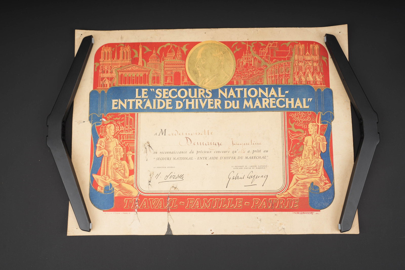 Diplome du Secours National. National Relief diploma.: Diplome du Secours National. En papier cartonne et en couleur. Texte en francais. Attribue a Mademoiselle Demange Jacqueline. M Schiffer Paris. Quelques reparations au scotch. Dimensions 30 x 50 cm.