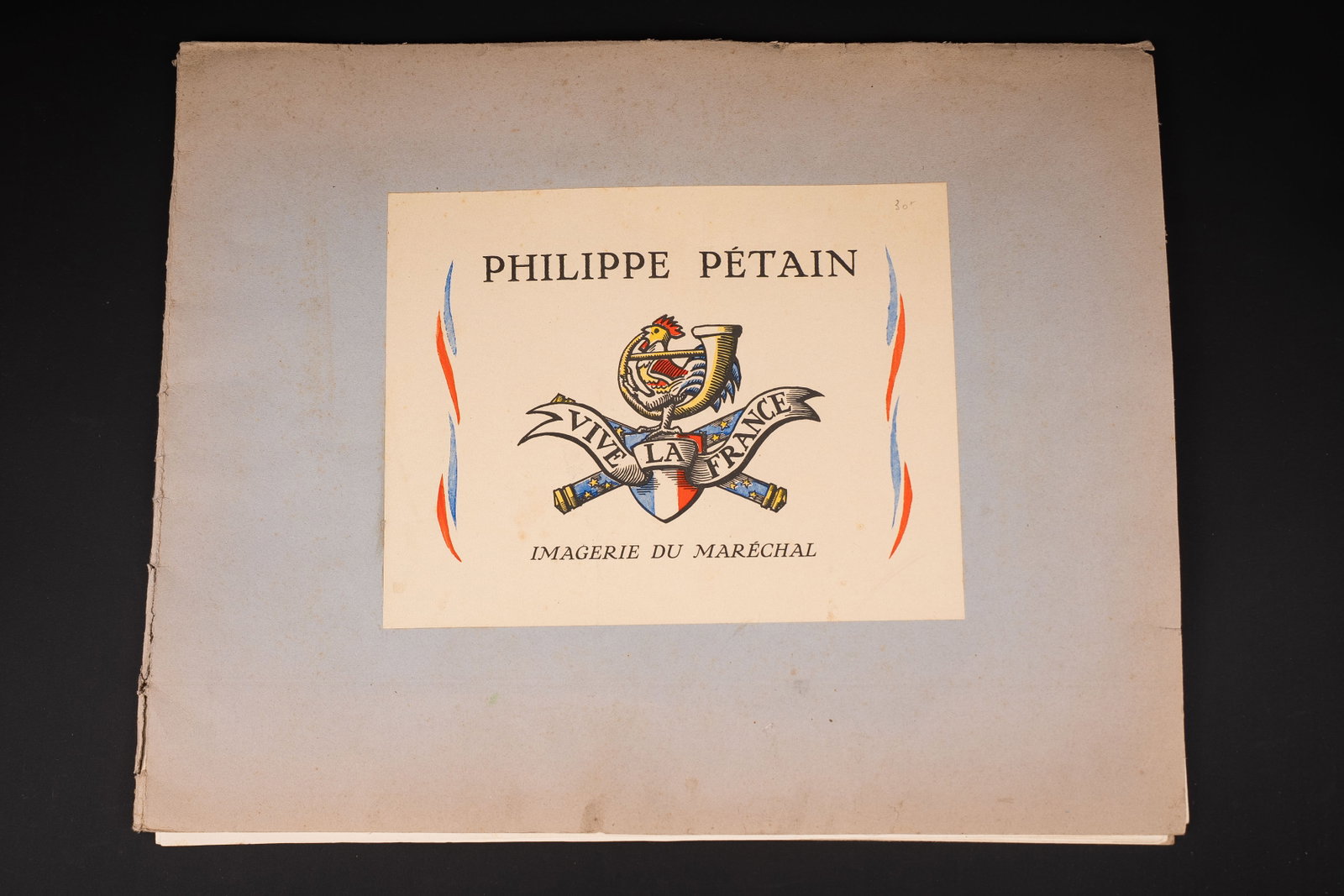 Imagerie du Marechal Petain. Marshal Petain imagery.: Imagerie du Marechal Petain. Couverture cartonnee. Bordure partiellement dechiree. 12 images completes. Imprime a Limoges en 1941. A noter une certaine usure et patine de la piece. Etat II+. Marshal