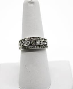 14K WG Diamond Ring A:$ 2,600: One lady's 14kt. white gold channel and bead set ring. Weight: 5.4g, Size: 6.75 containing: Stone1Stone2 QUANTITY:7 Natural Diamond32 Natural Diamond SHAPE:Round Brilliant CutRound Brilliant Cut WEIGH