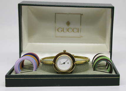 Gucci Interchangable Bezels Watch 1100L: ----DESCRIPTION---- A Beautiful Ladies Gucci Vintage18K gold plated 1100L 11/12 Bezel wristwatch in excellent condition, 10 interchangeable colored bezels. Comes with ORIGINAL box and Papers -----